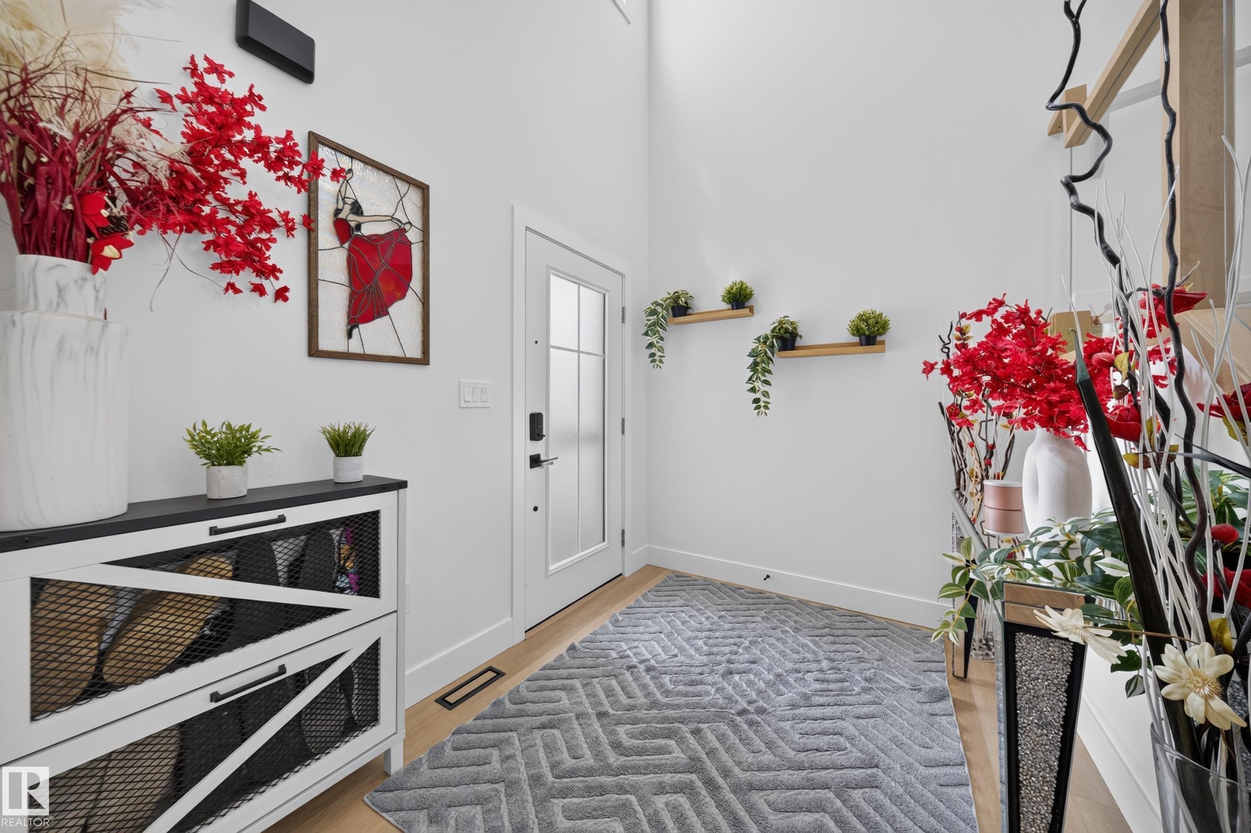 Entryway featuring light wood-finish flooring and a white paneled door with frosted glass inserts - 626 Astoria Way, Devon, AB