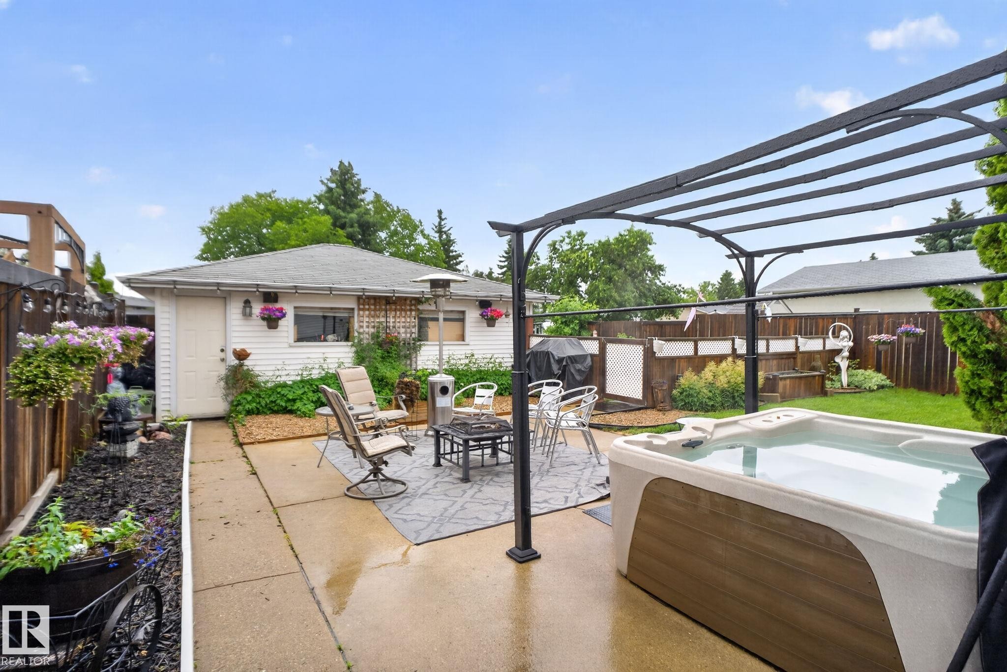 Backyard featuring a swim spa, concrete patio, and a metal pergola structure - 7539 149A Avenue Nw, Edmonton, AB - Outdoor