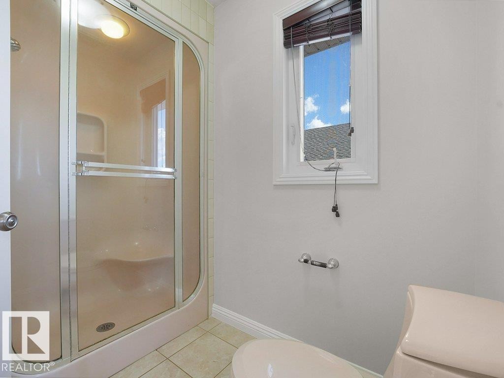 Enclosed shower with frosted glass panels and integrated lighting - 2423 Tegler Green, Edmonton, AB