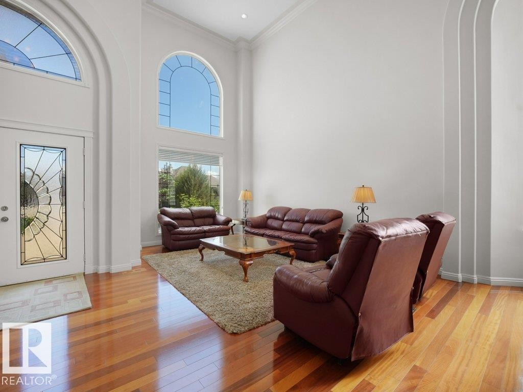 Two-story living area featuring a vaulted ceiling and wood-finish flooring - 2423 Tegler Green, Edmonton, AB