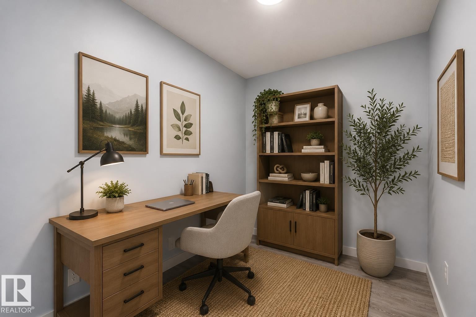 Dedicated office space featuring light wood-finish flooring, a built-in light wood desk with drawers, and a matching light wood open-shelf bookcase with lower cabinet storage - 403 25 Element Dr, St. Albert, AB - Indoor Photo Showing Office