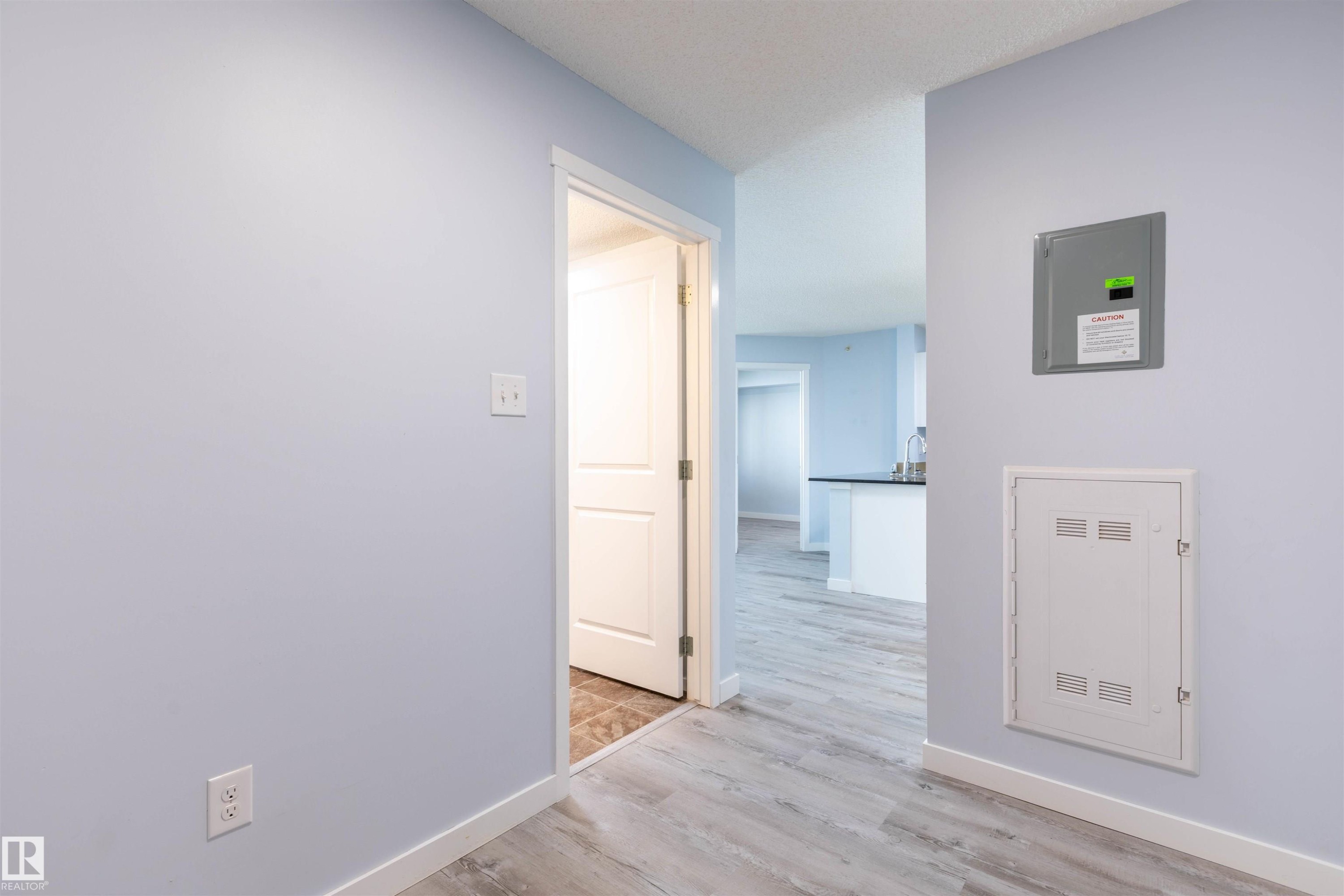 Light blue painted walls with white trim and wood-finish flooring - 403 25 Element Dr, St. Albert, AB - Indoor Photo Showing Other Room
