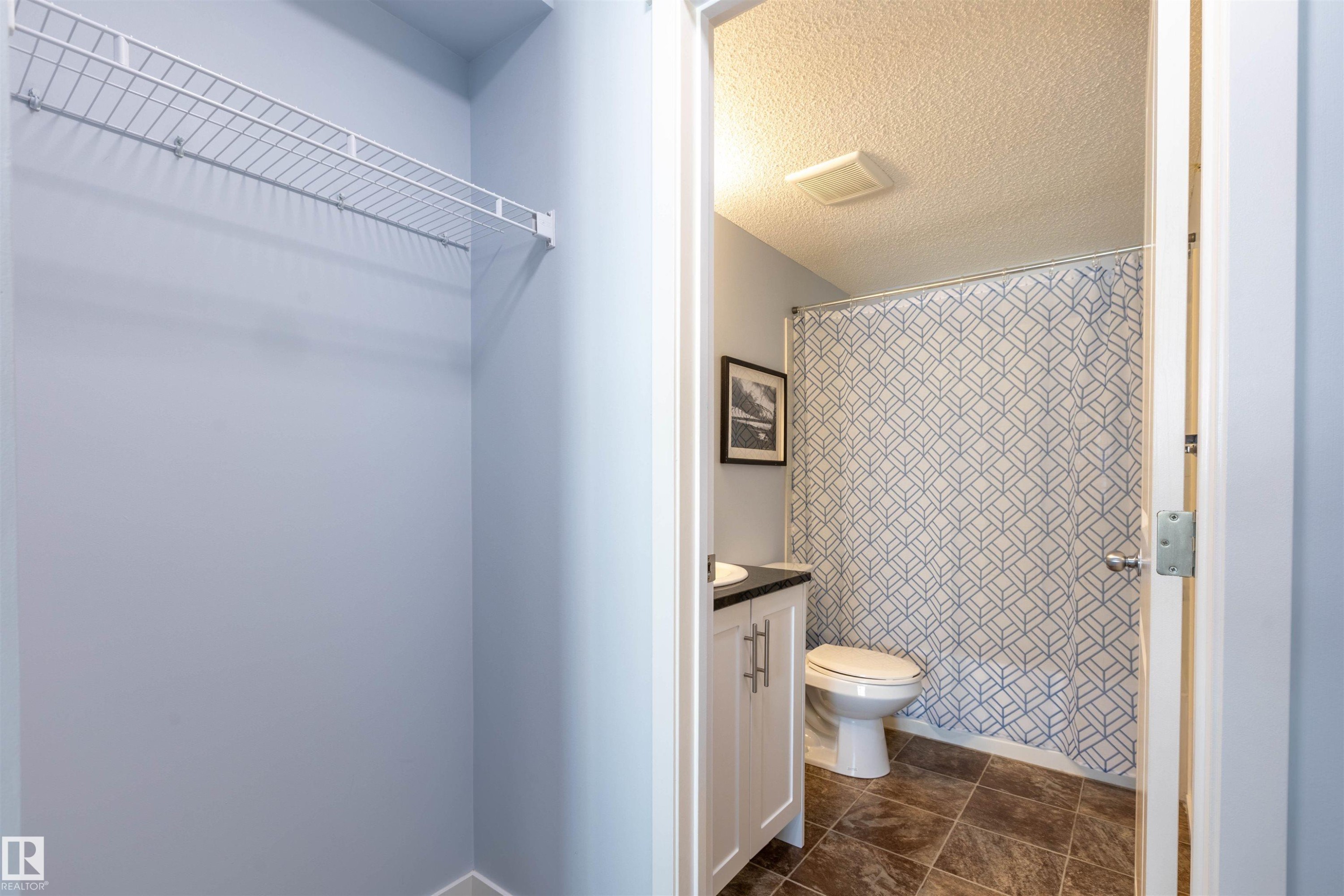 Bathroom with white vanity, dark countertop, and tiled flooring - 403 25 Element Dr, St. Albert, AB - Indoor Photo Showing Bathroom