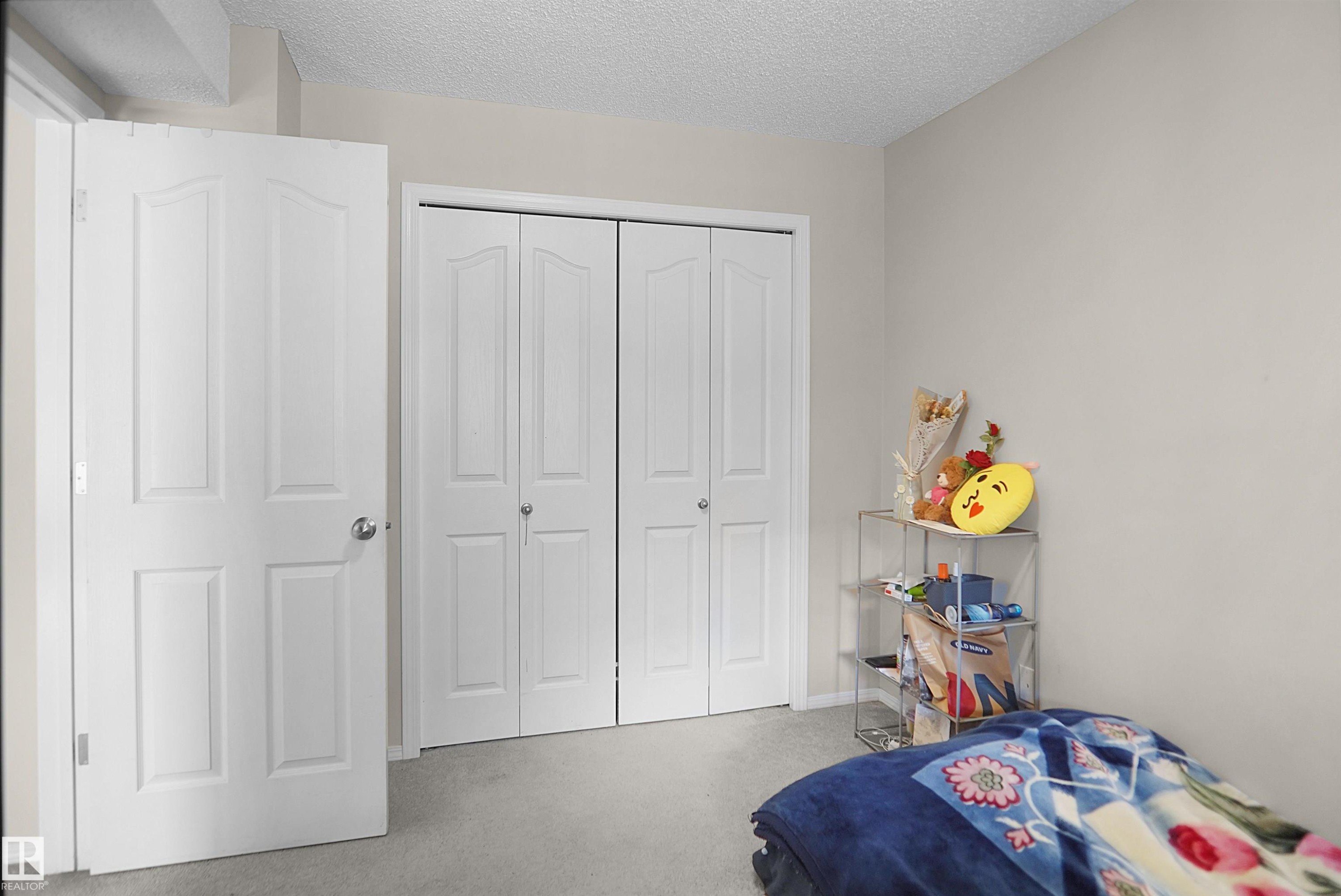Neutral-toned walls complement the light gray carpeting - 215 1070 Mcconachie Blvd, Edmonton, AB