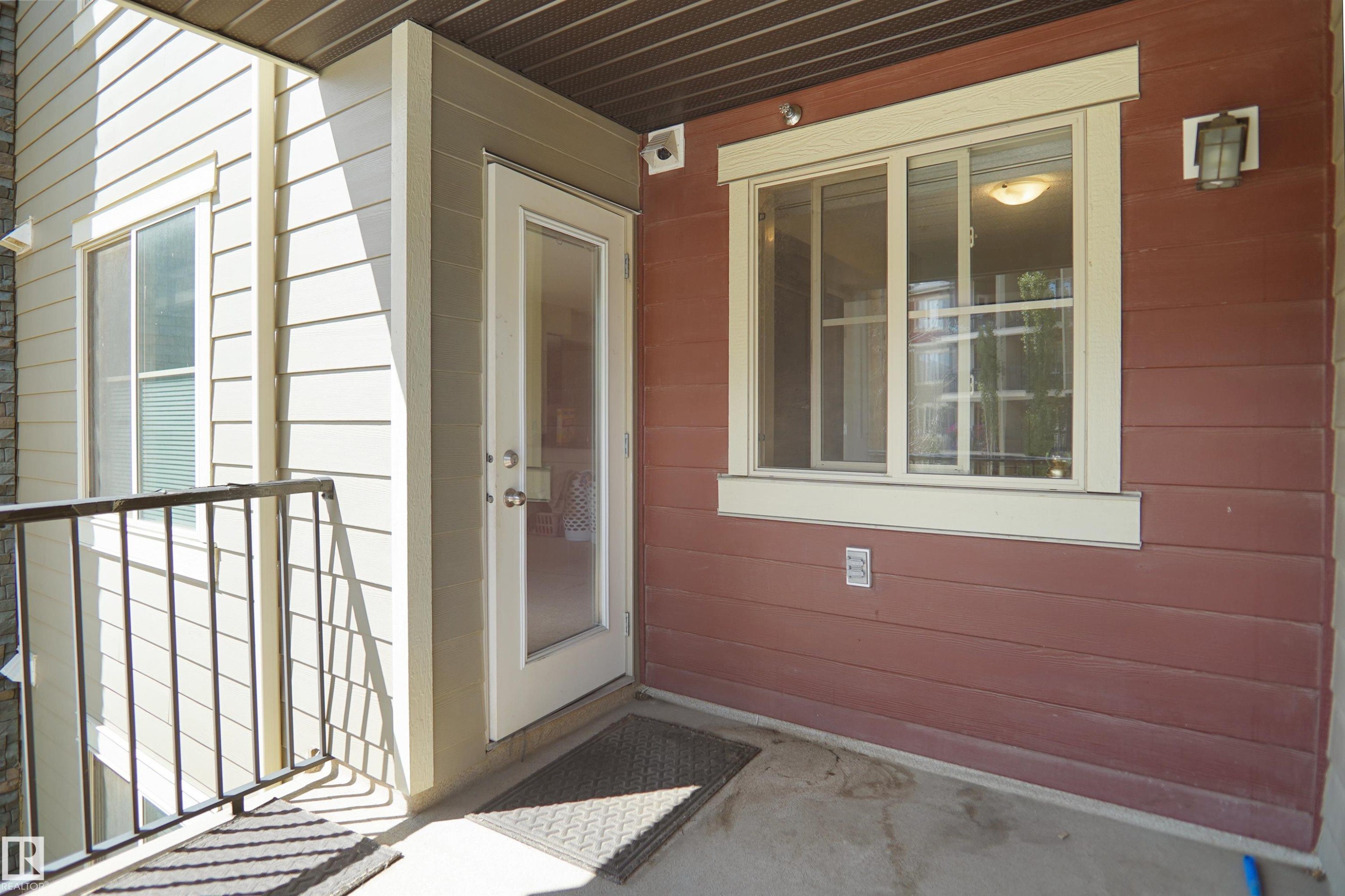 Exterior balcony featuring a concrete floor and black metal railing - 215 1070 Mcconachie Blvd, Edmonton, AB