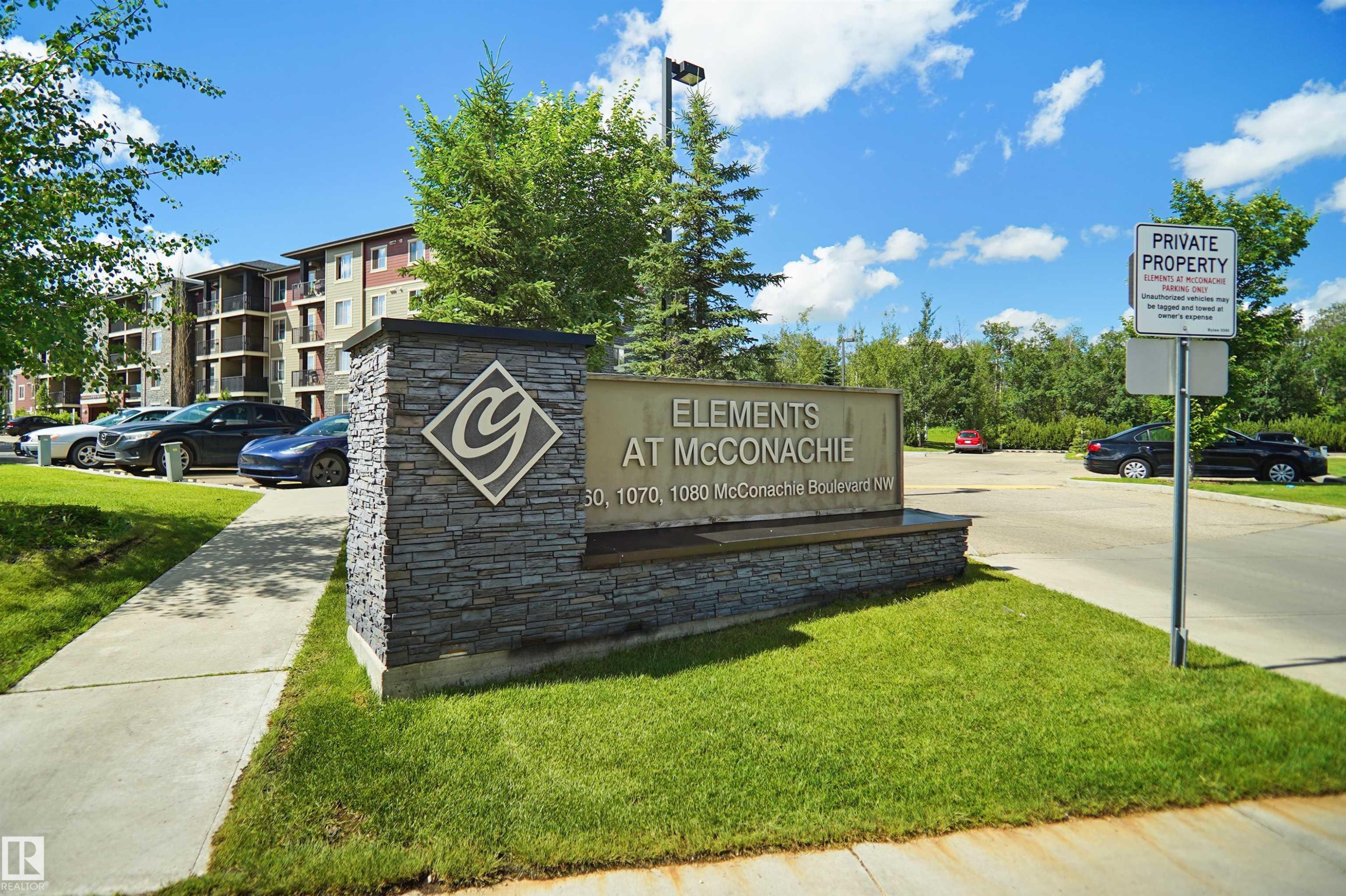 Stone-clad monument sign featuring property branding - 215 1070 Mcconachie Blvd, Edmonton, AB
