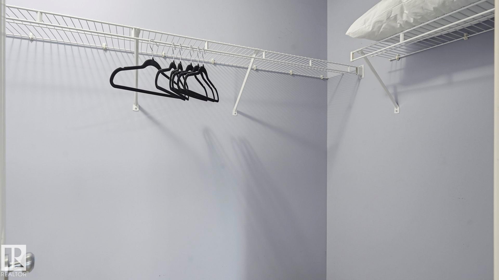 Built-in wire shelving system with white finish, providing ample storage capacity - 3591 Mclean Crescent, Edmonton, AB