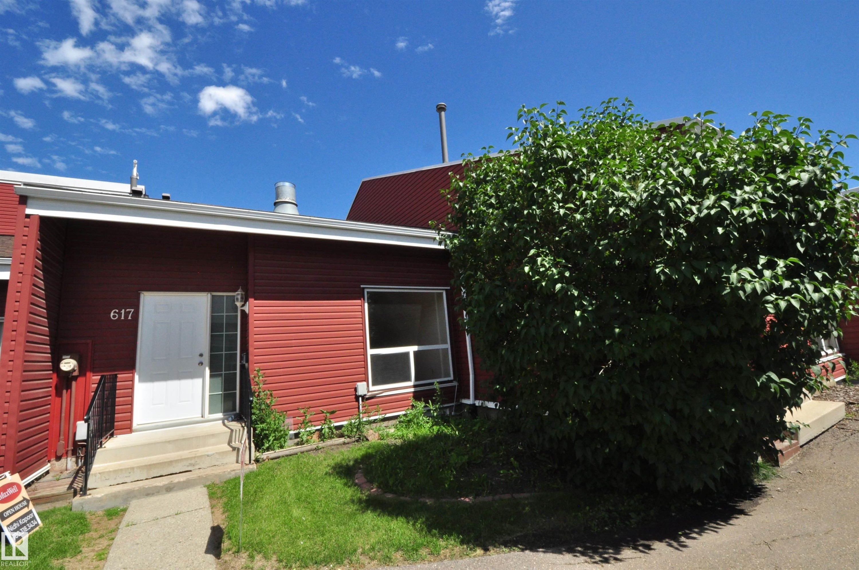 Red horizontal siding exterior with a white entry door and a large front window - 617 Millbourne Road E, Edmonton, AB
