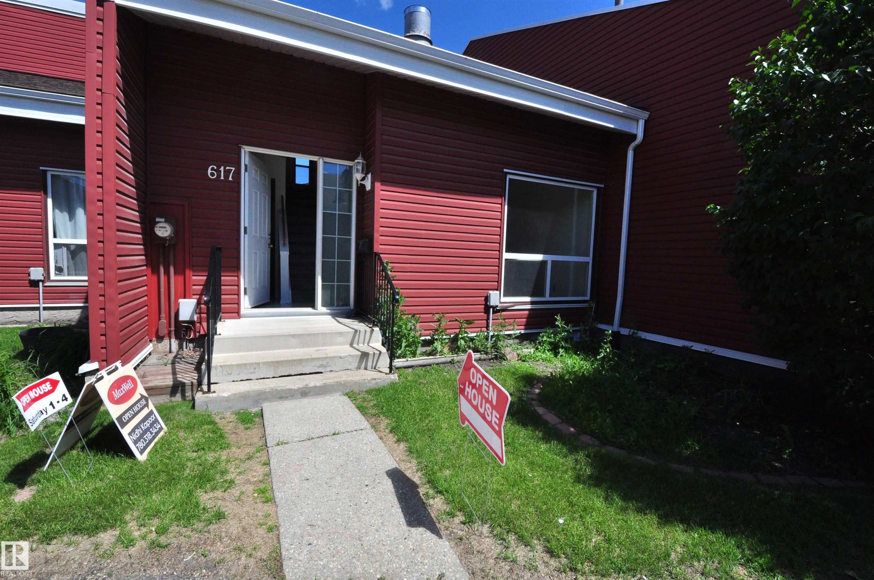 Red siding exterior featuring white trim and a concrete entry path - 617 Millbourne Road E, Edmonton, AB
