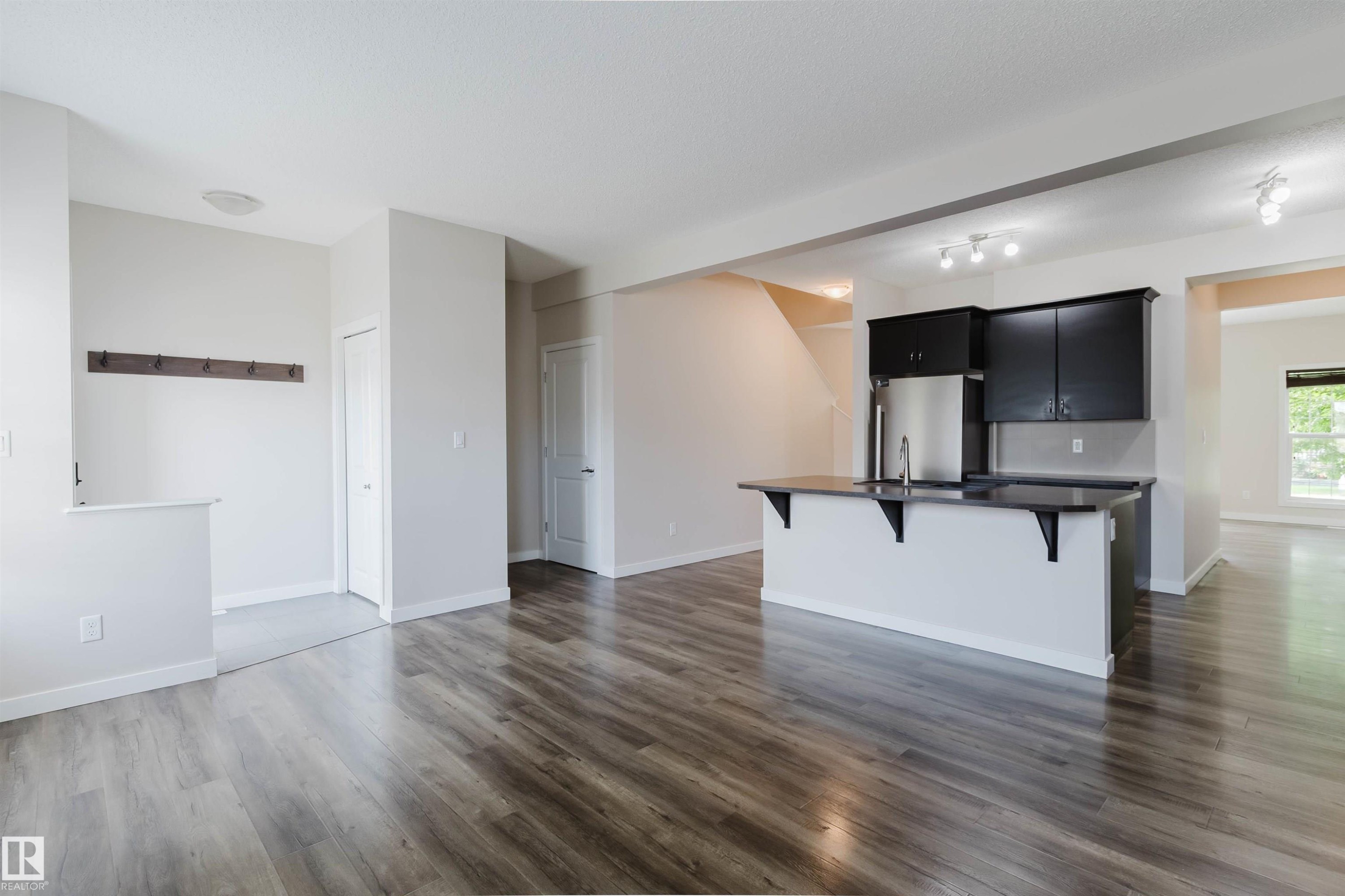 Open-concept living space with wood-finish flooring - 636 Mcdonough Link Link, Edmonton, AB