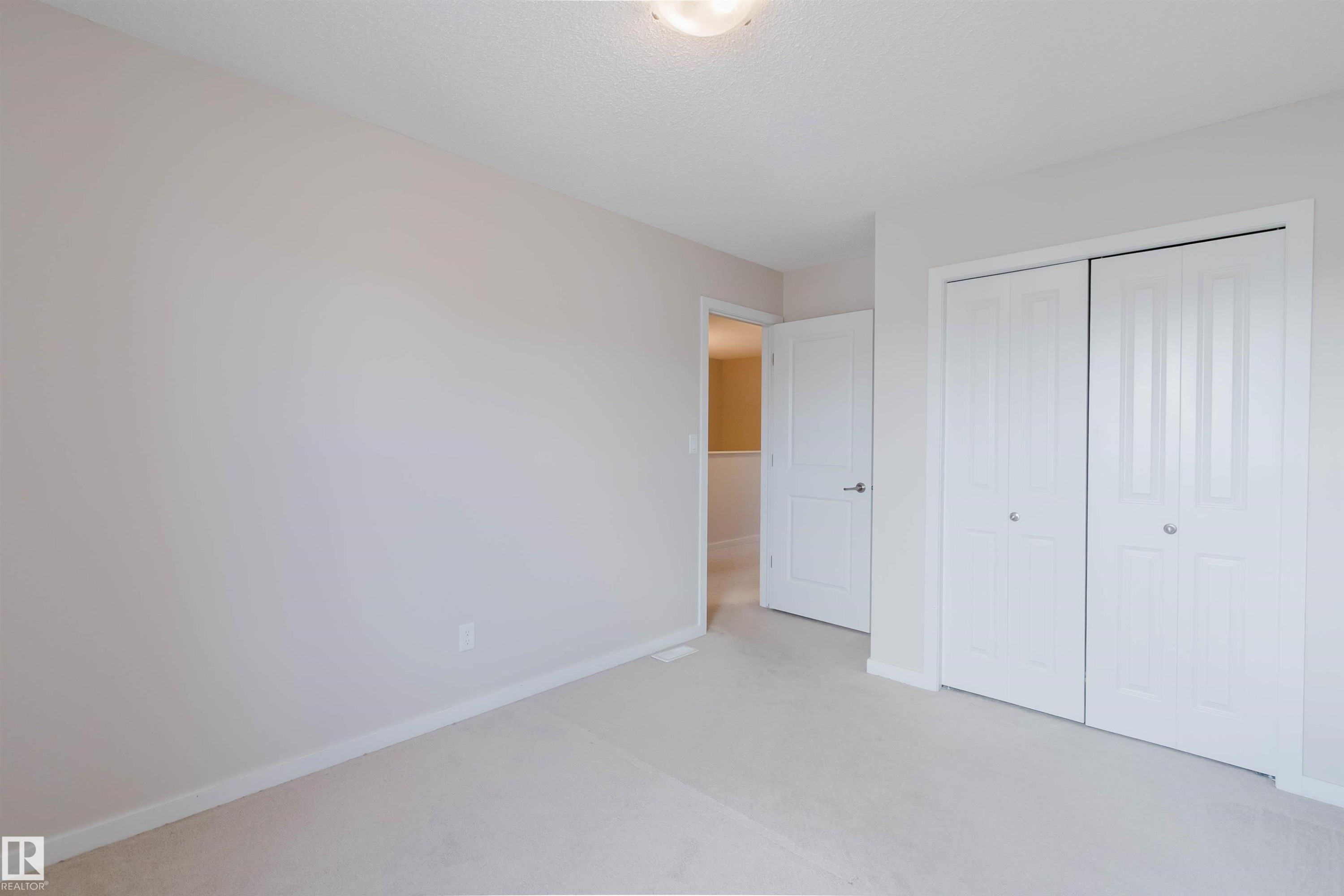 Neutral-toned walls complement plush carpeting throughout - 636 Mcdonough Link Link, Edmonton, AB