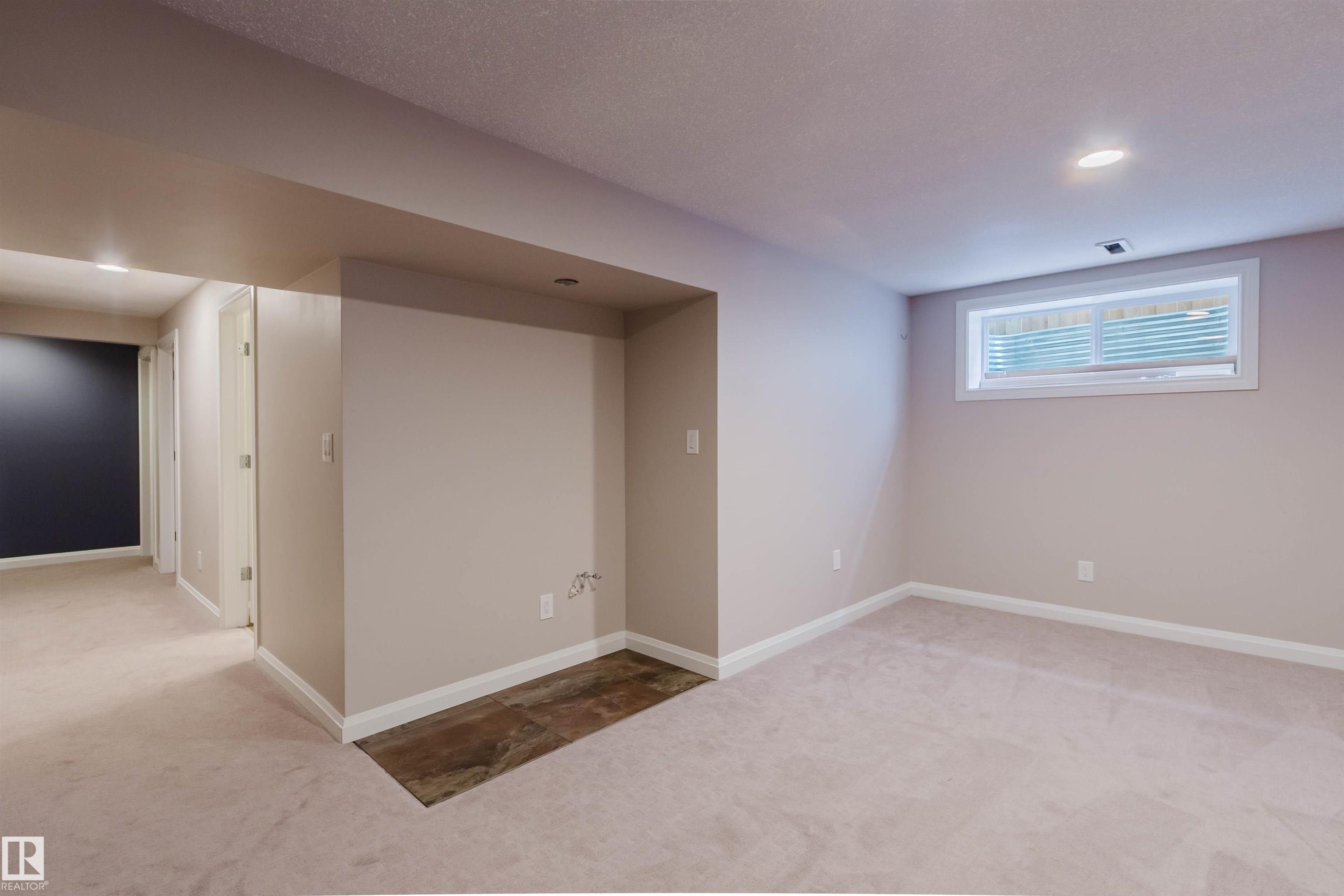 Finished lower level featuring recessed lighting, plush carpeting, an egress window, and a wood-finish flooring inset - 636 Mcdonough Link Link, Edmonton, AB