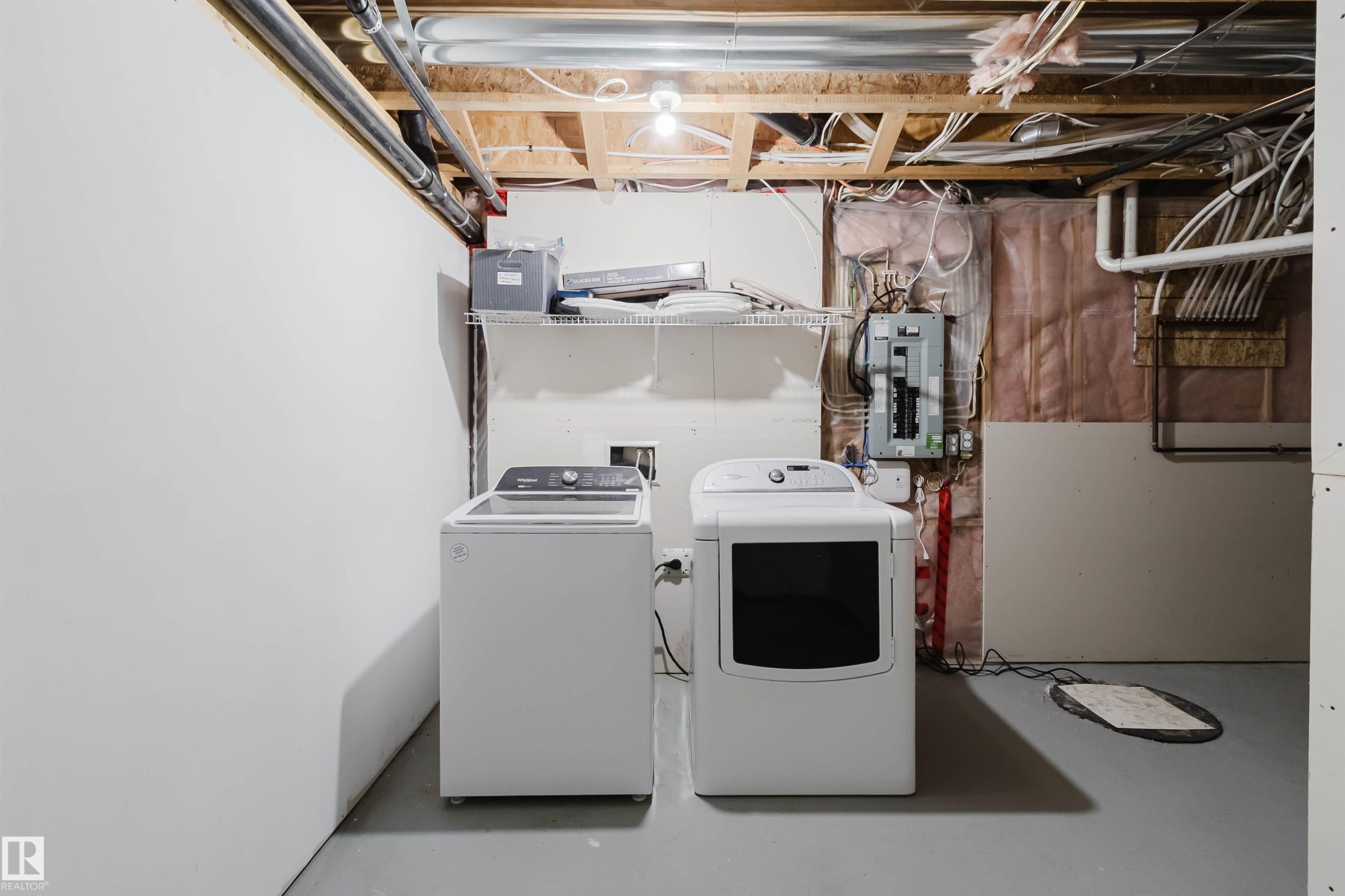 Utility area featuring a top-load washing machine and a front-load dryer - 636 Mcdonough Link Link, Edmonton, AB