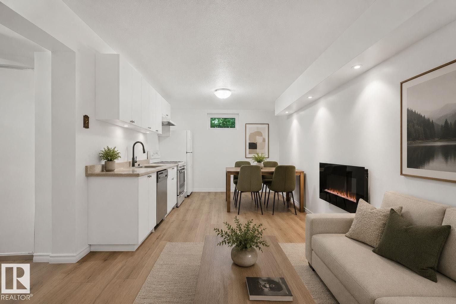 Open-concept living space featuring wood-finish flooring, recessed lighting, and a wall-mounted electric fireplace - 12238 48 Street, Edmonton, AB