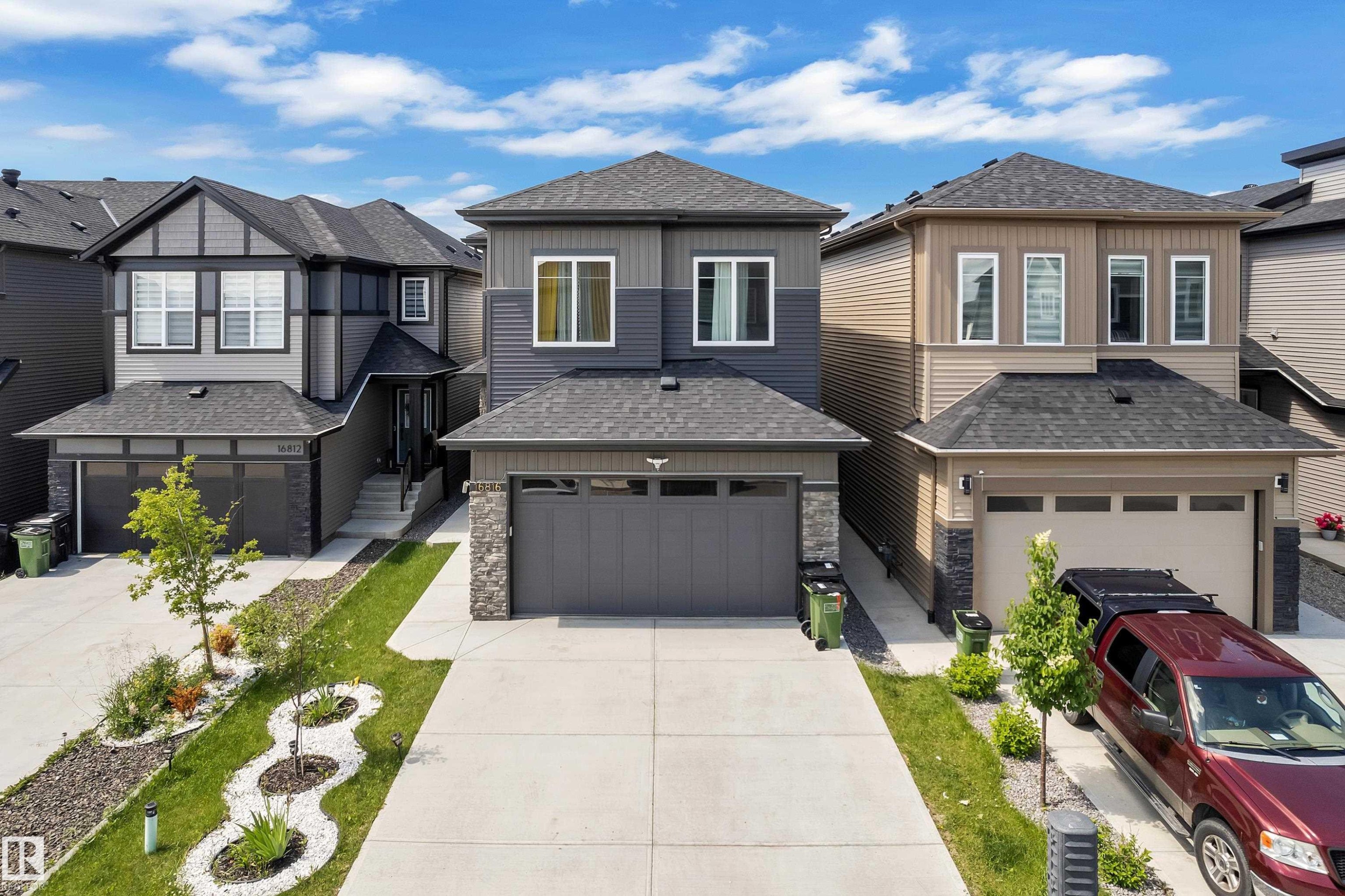 Modern two-story residence featuring a gray and charcoal facade with horizontal and vertical siding - 16816 49 Street, Edmonton, AB