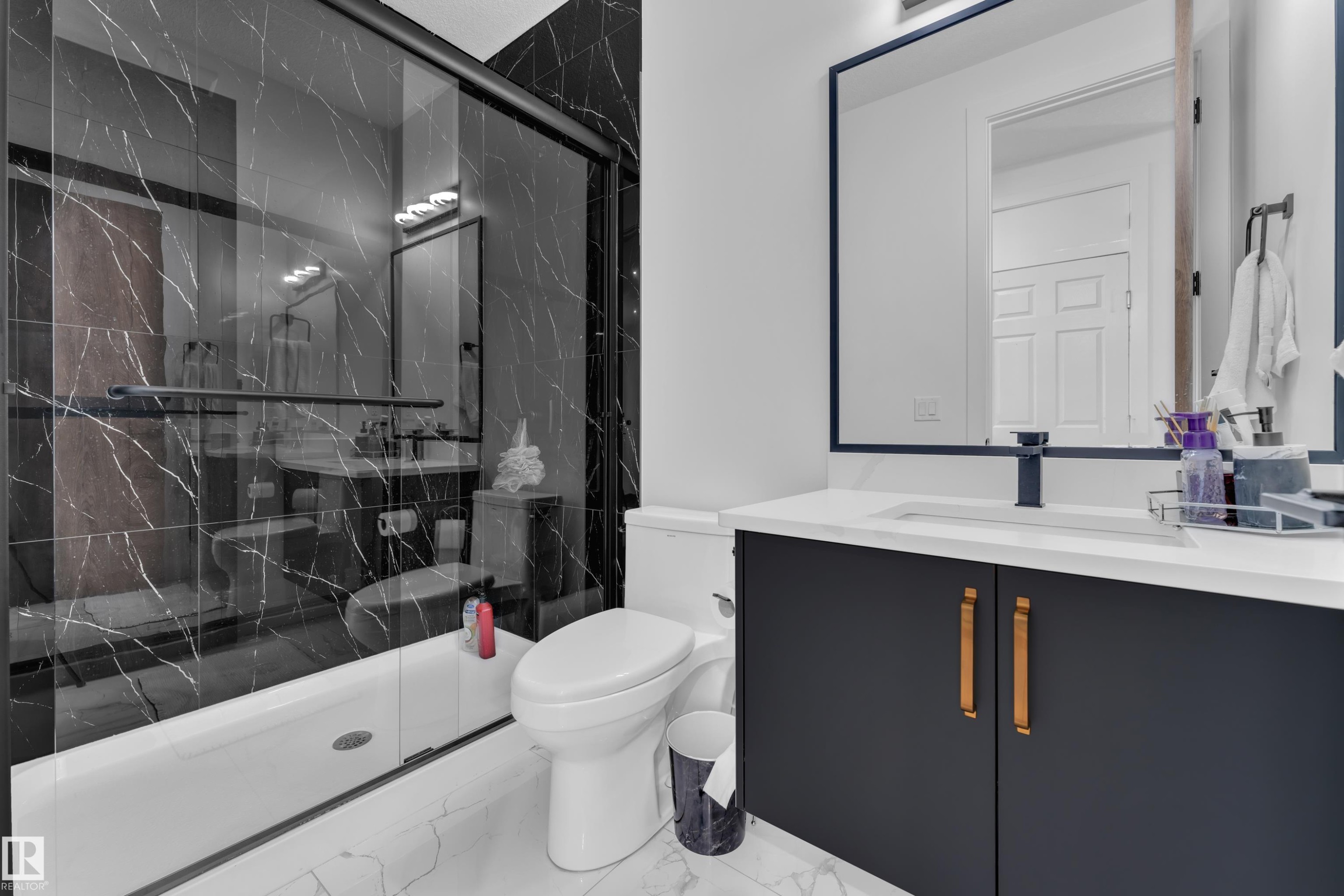 Bathroom featuring a black marble-patterned shower surround with a sliding glass door - 16816 49 Street, Edmonton, AB