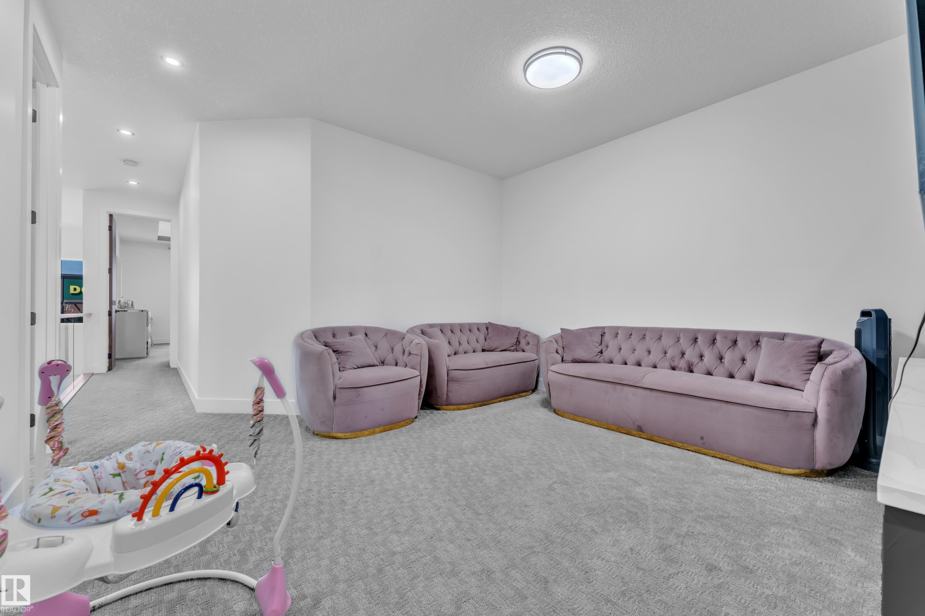 Carpeted room with white walls, recessed lighting, and a flush-mount ceiling fixture - 16816 49 Street, Edmonton, AB