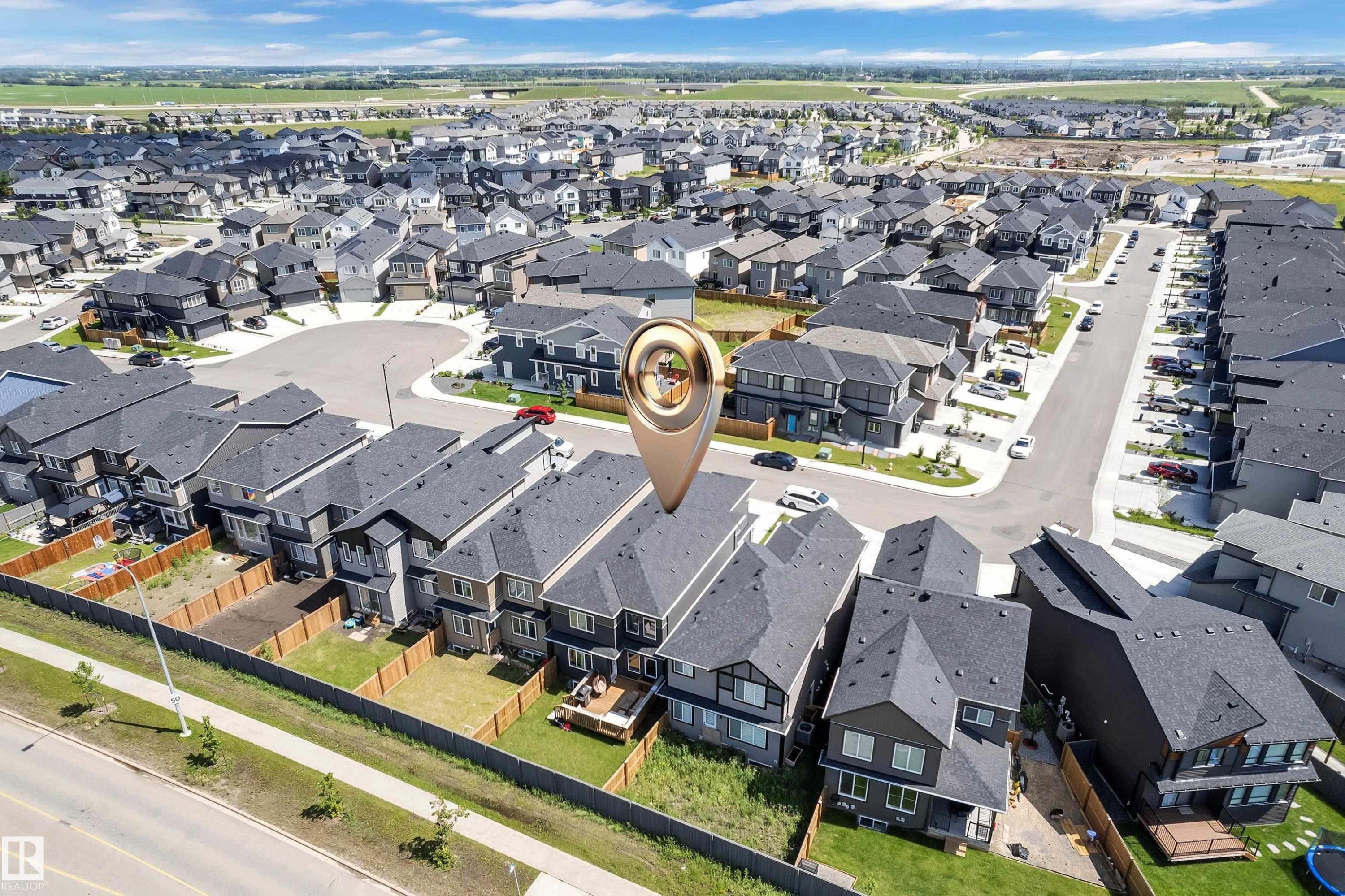 Aerial view showcasing a suburban neighborhood with numerous residences featuring dark shingled roofs and varied exterior finishes - 16816 49 Street, Edmonton, AB