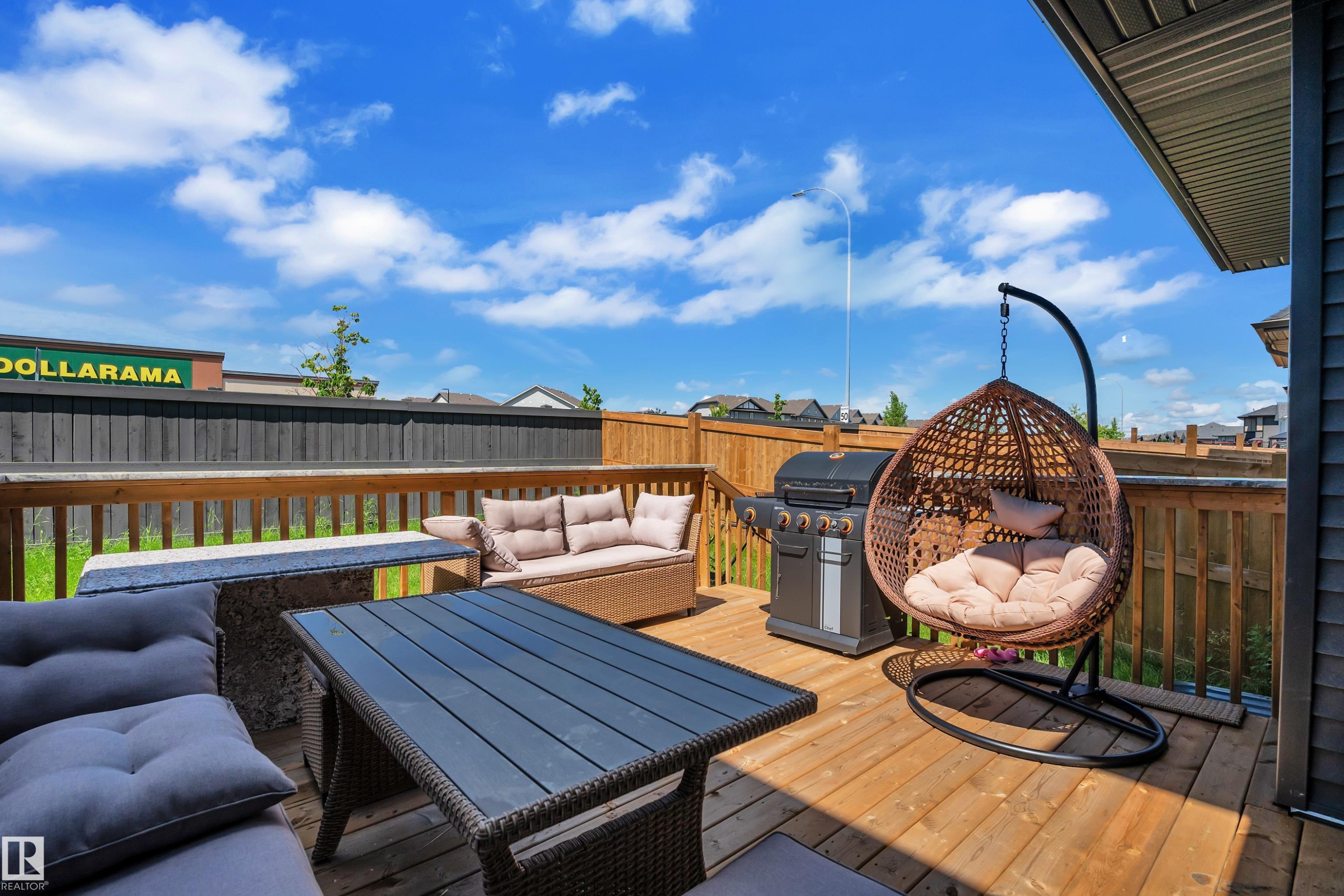 Spacious outdoor deck featuring natural wood flooring and railing - 16816 49 Street, Edmonton, AB