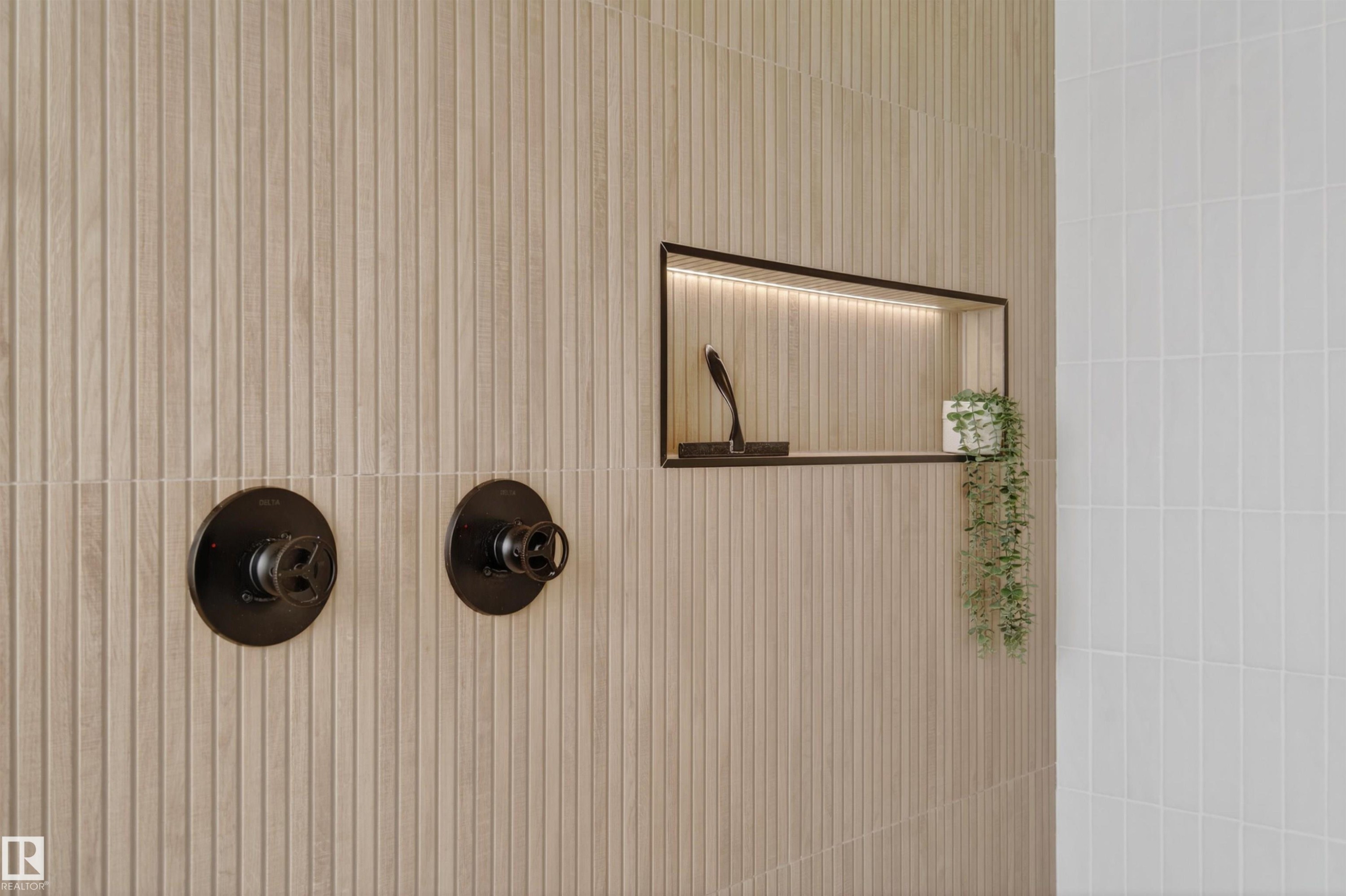 Textured paneling with integrated shower niche featuring recessed lighting and matte black fixtures - 711 Beach Avenue, Cold Lake, AB -