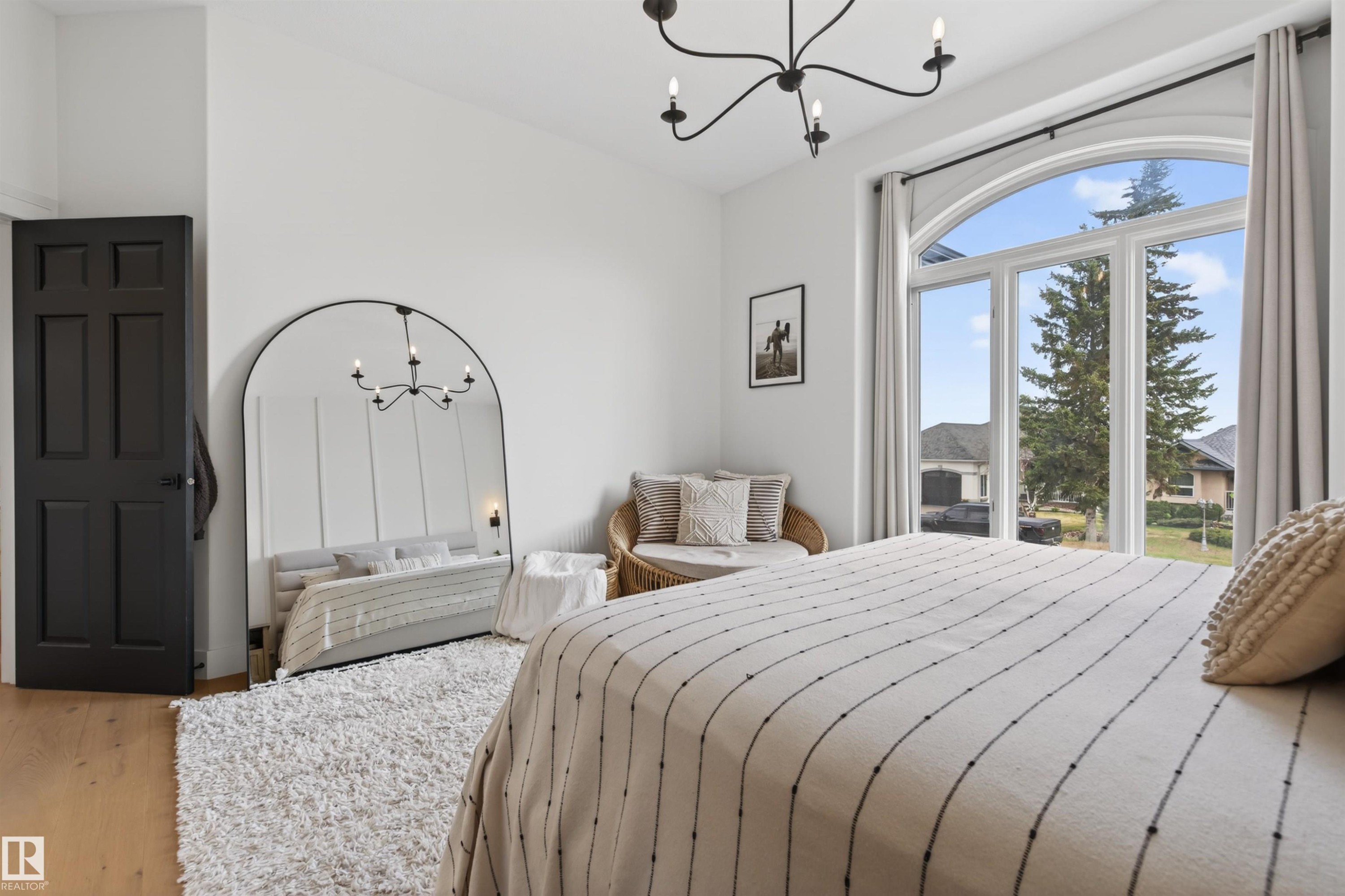 Arch-top window with multi-pane design - 711 Beach Avenue, Cold Lake, AB - Indoor Photo Showing Bedroom