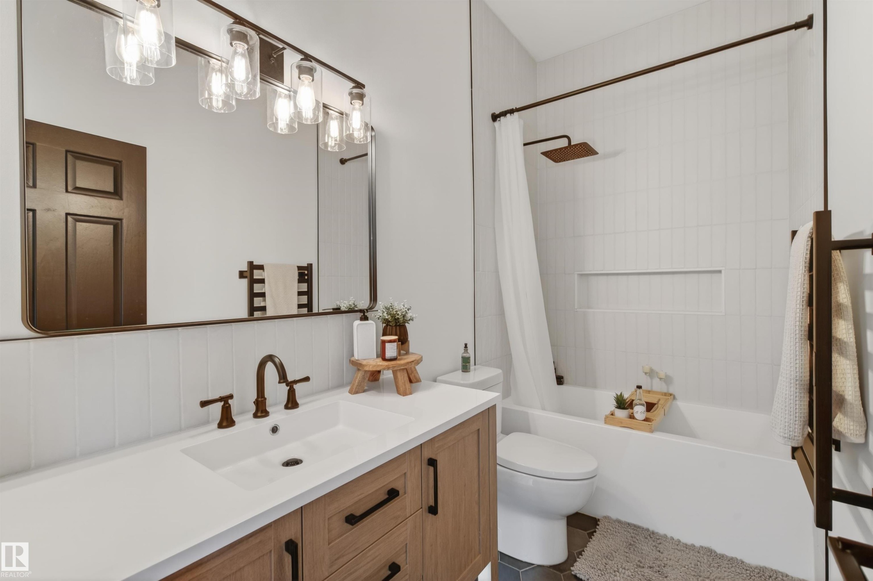 Modern bathroom featuring a single vanity with a white countertop and wood-finish cabinetry - 711 Beach Avenue, Cold Lake, AB - Indoor Photo Showing Bathroom