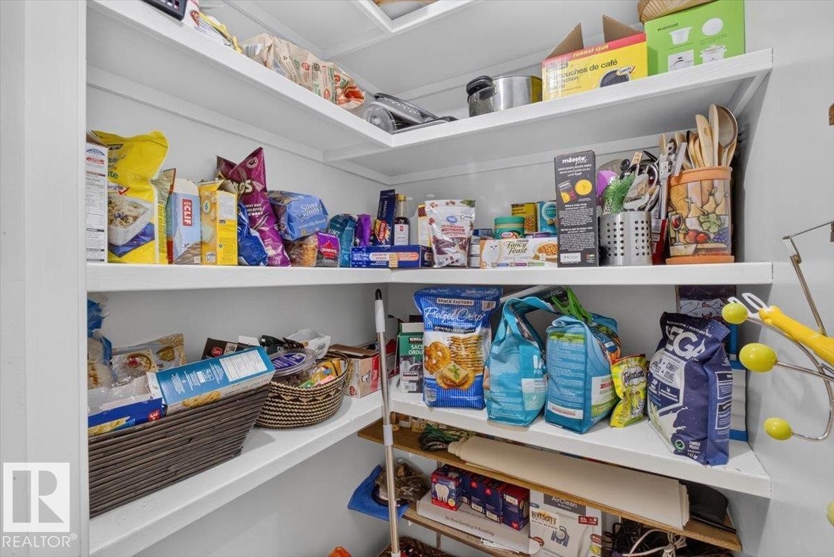 Corner pantry with white shelving - 10736 48 Street Nw, Edmonton, AB - Indoor With Storage