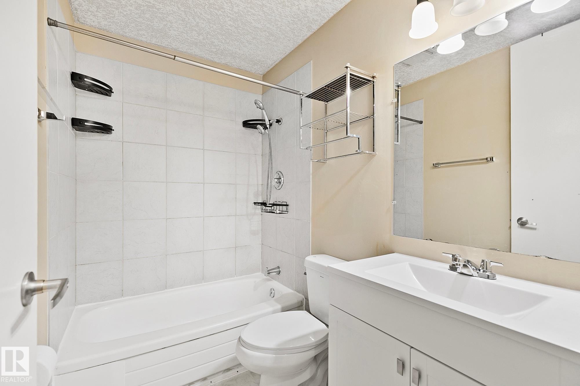 Bathroom featuring a white tiled shower and bathtub combination - 17059 98 Street, Edmonton, AB - Indoor Photo Showing Bathroom