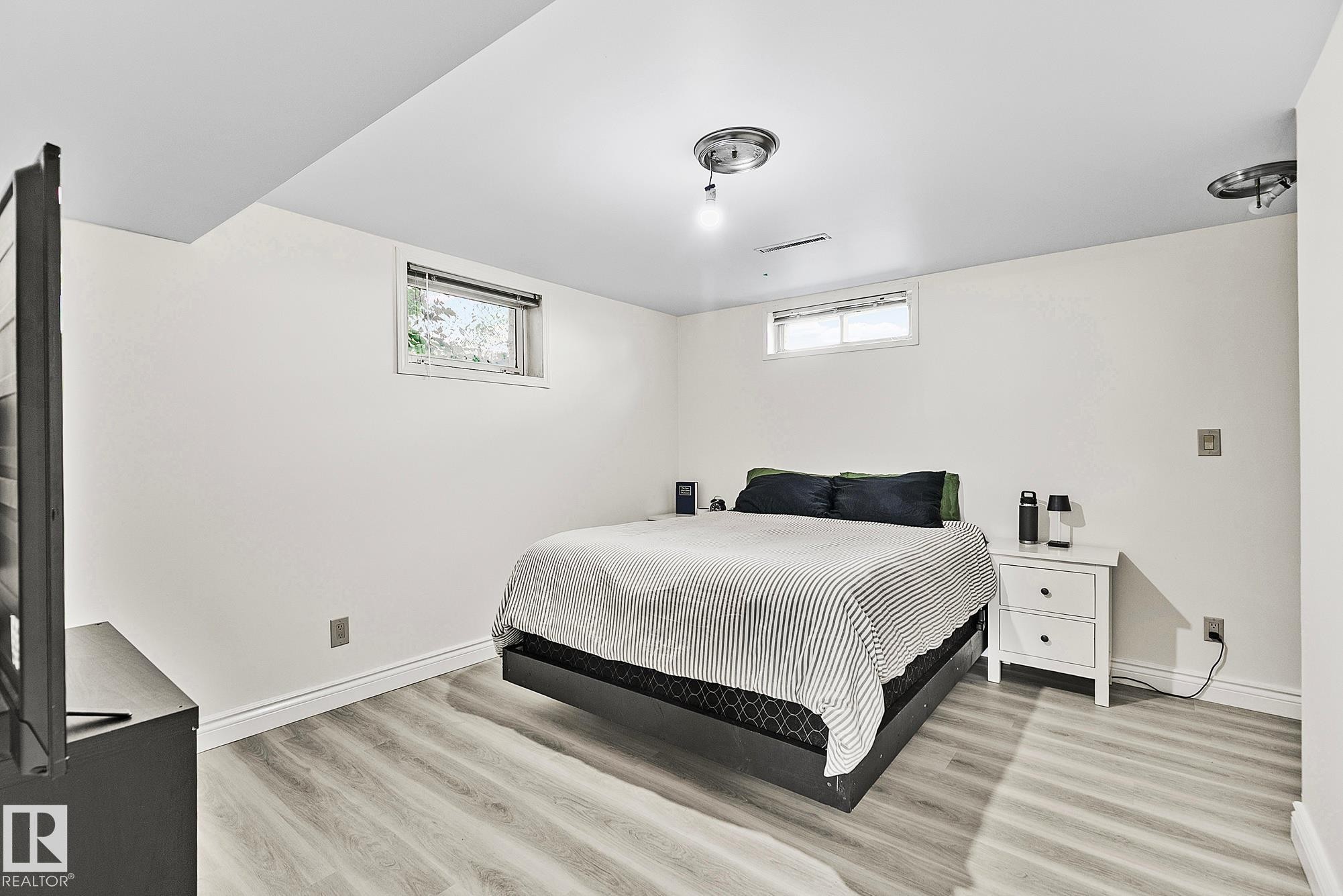 Bedroom featuring light wood-finish flooring, recessed windows, and flush-mount ceiling lighting - 17059 98 Street, Edmonton, AB - Indoor Photo Showing Bedroom