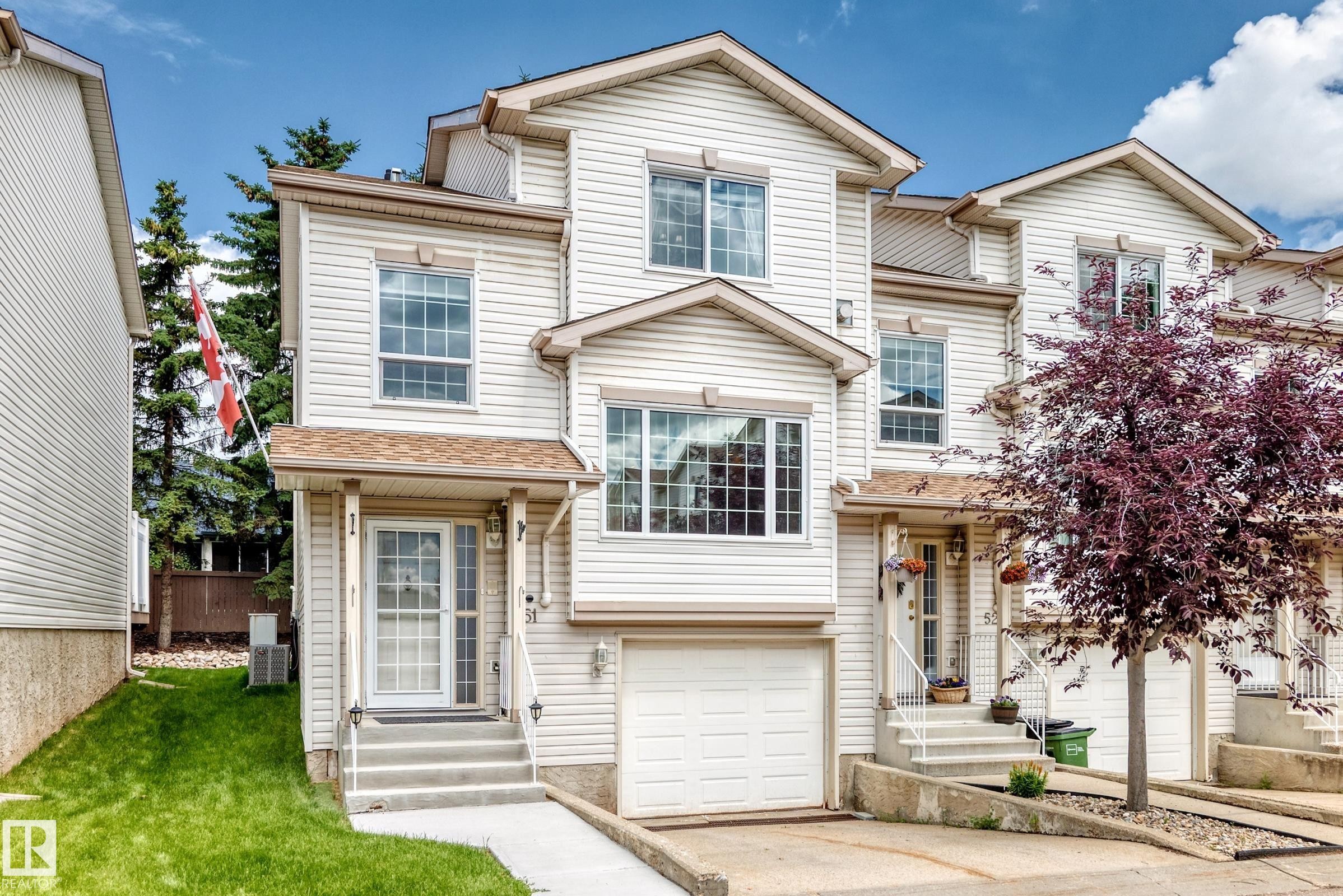 Cream-colored siding exterior featuring multiple gables and a covered front entry - #51 9630 176 St Nw, Edmonton, AB - Outdoor With Facade