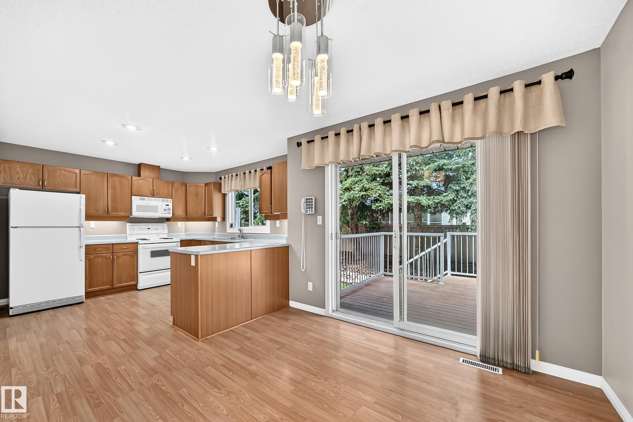 Open concept kitchen and dining area with wood-finish flooring - #51 9630 176 St Nw, Edmonton, AB - Indoor Photo Showing Kitchen