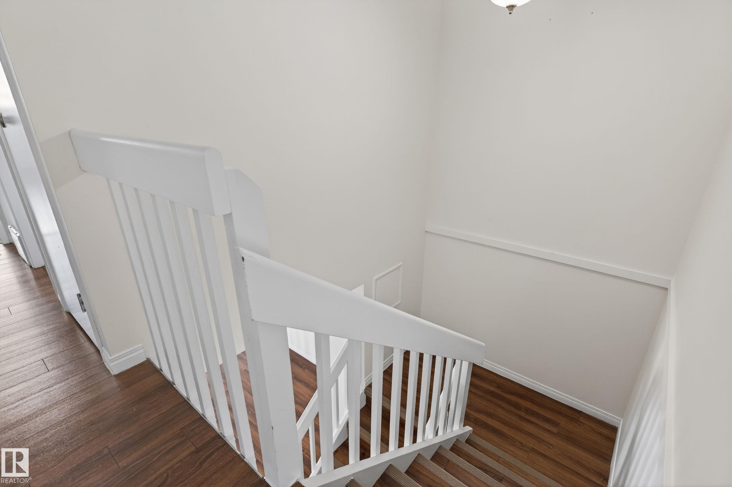 Stairwell featuring white painted railings, wood-finish flooring, and white wall finishes - 156 Lee Ridge Road, Edmonton, AB - Indoor Photo Showing Other Room