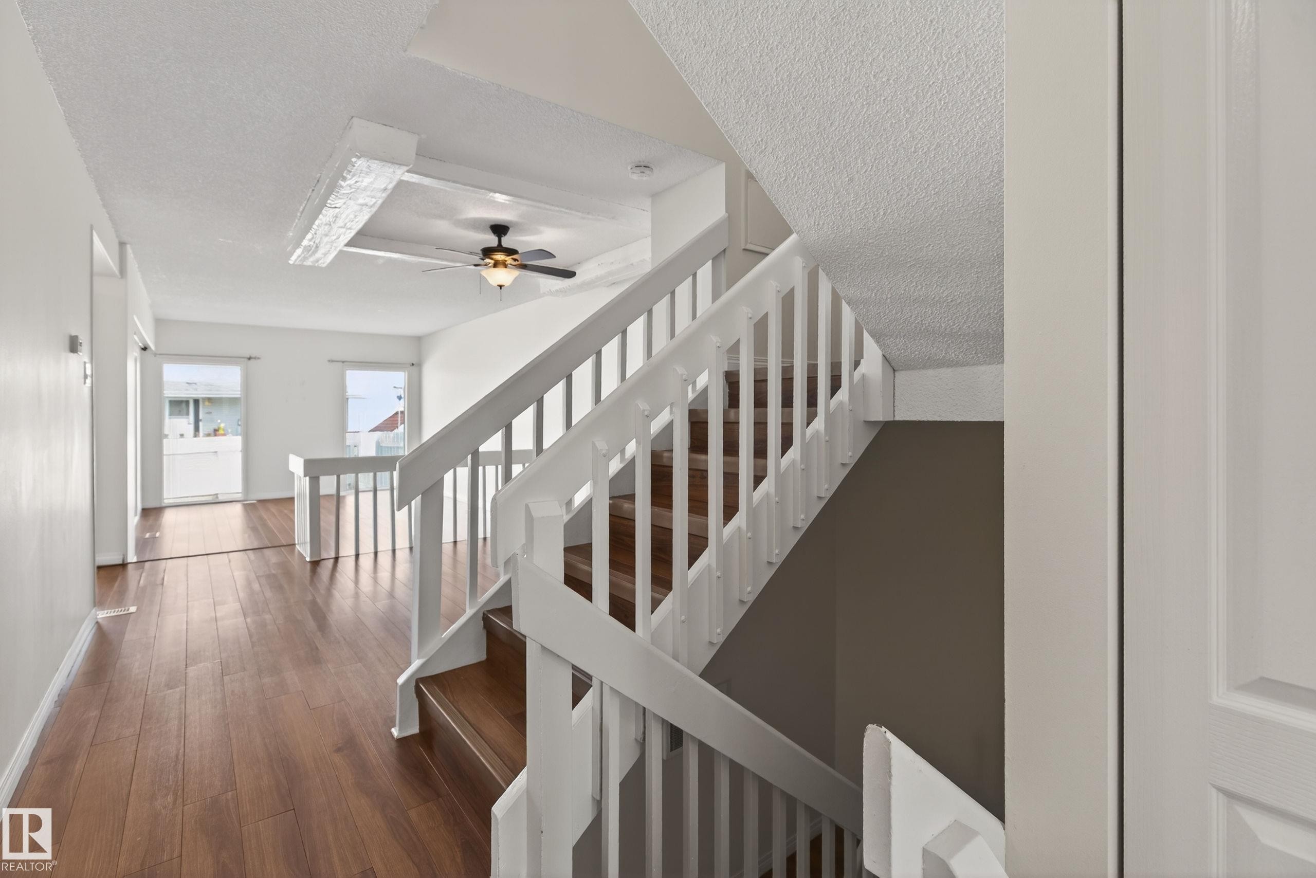 White baluster staircase with wood-finish treads - 156 Lee Ridge Road, Edmonton, AB - Indoor Photo Showing Other Room