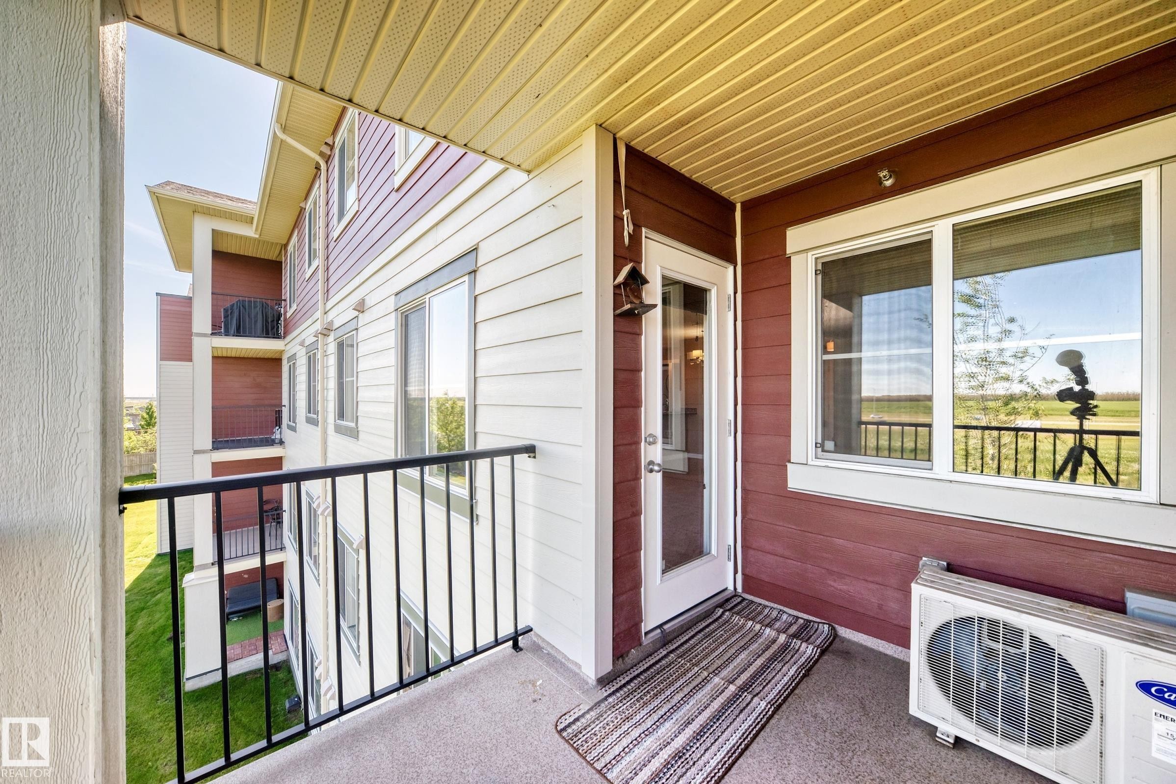 Private balcony featuring a concrete floor and black metal railings - 308 18126 77 Street, Edmonton, AB