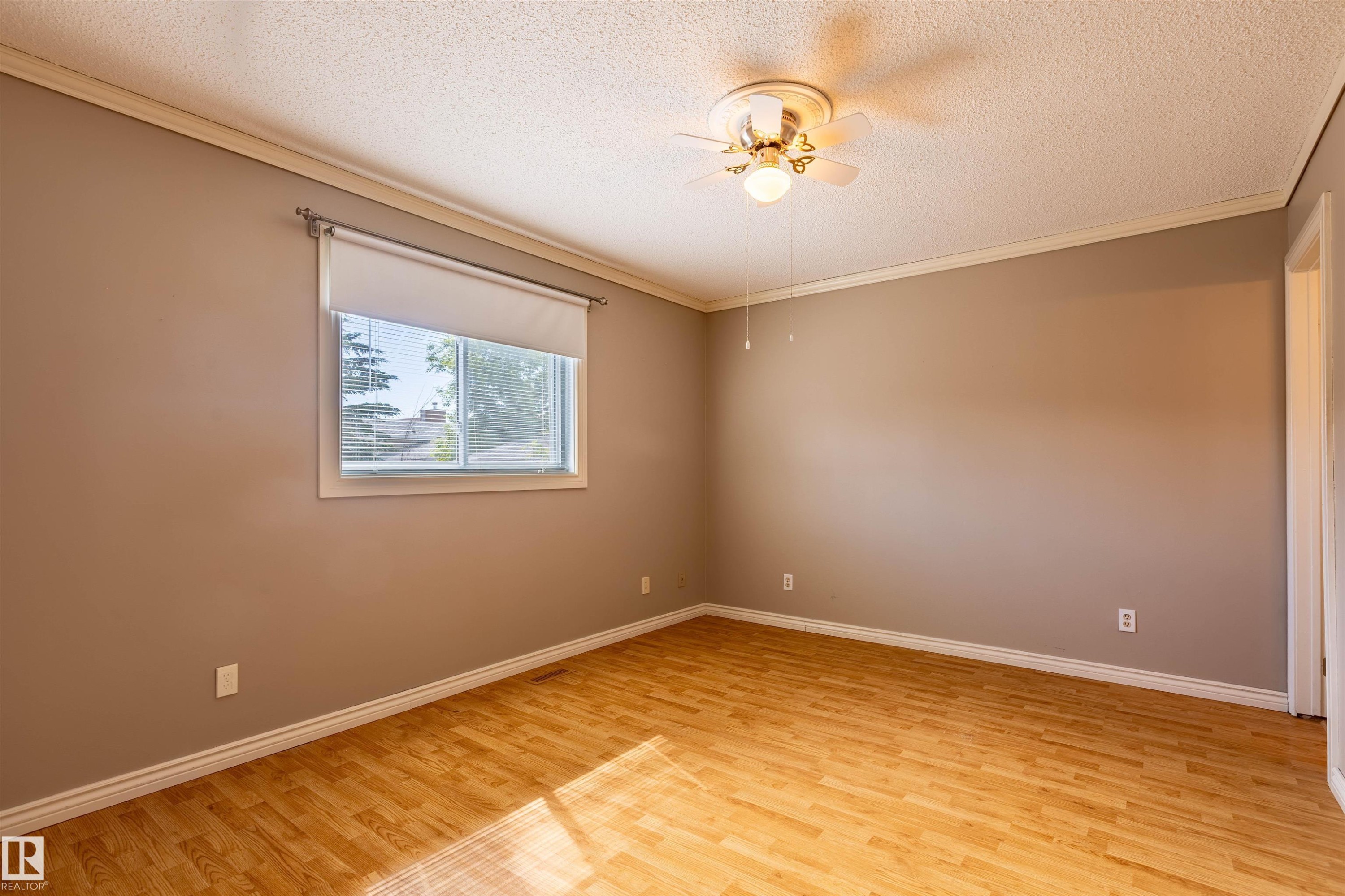 Room featuring wood-finish flooring, neutral wall paint, and white baseboards - 3 Glenforest Crescent, Stony Plain, AB