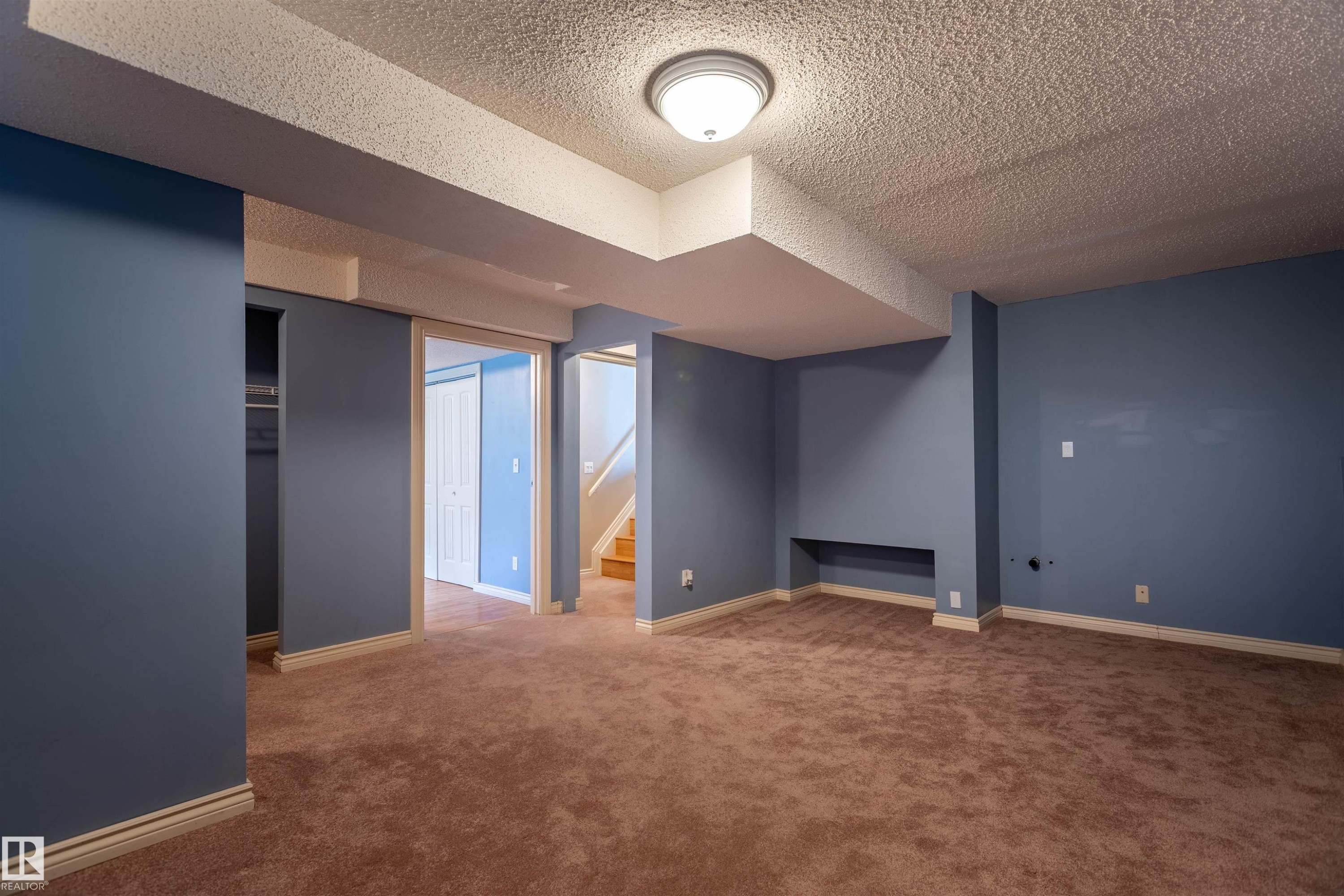 Carpeted interior space with blue walls and white trim - 3 Glenforest Crescent, Stony Plain, AB