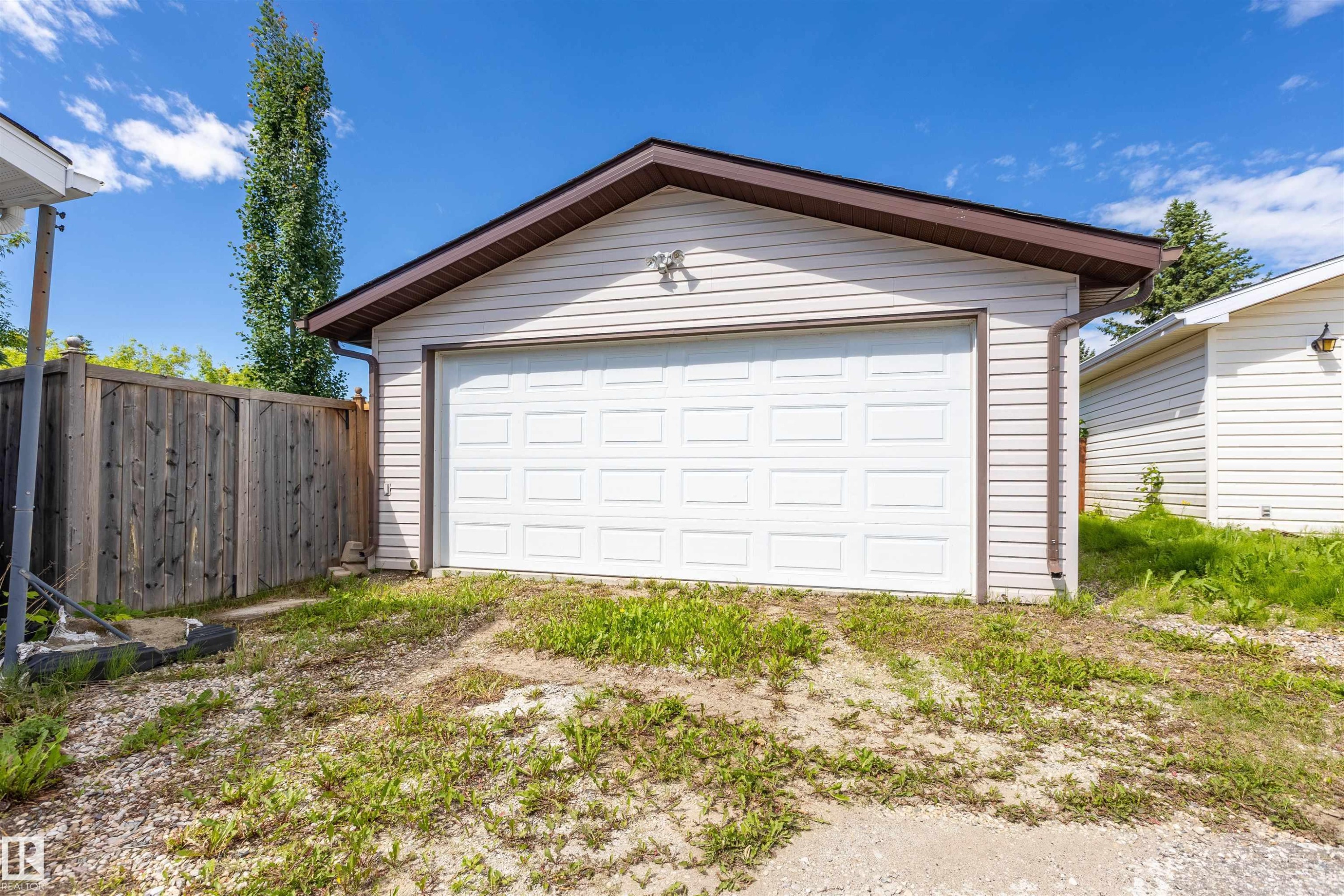 Detached garage with white panel door and light-toned siding - 3 Glenforest Crescent, Stony Plain, AB