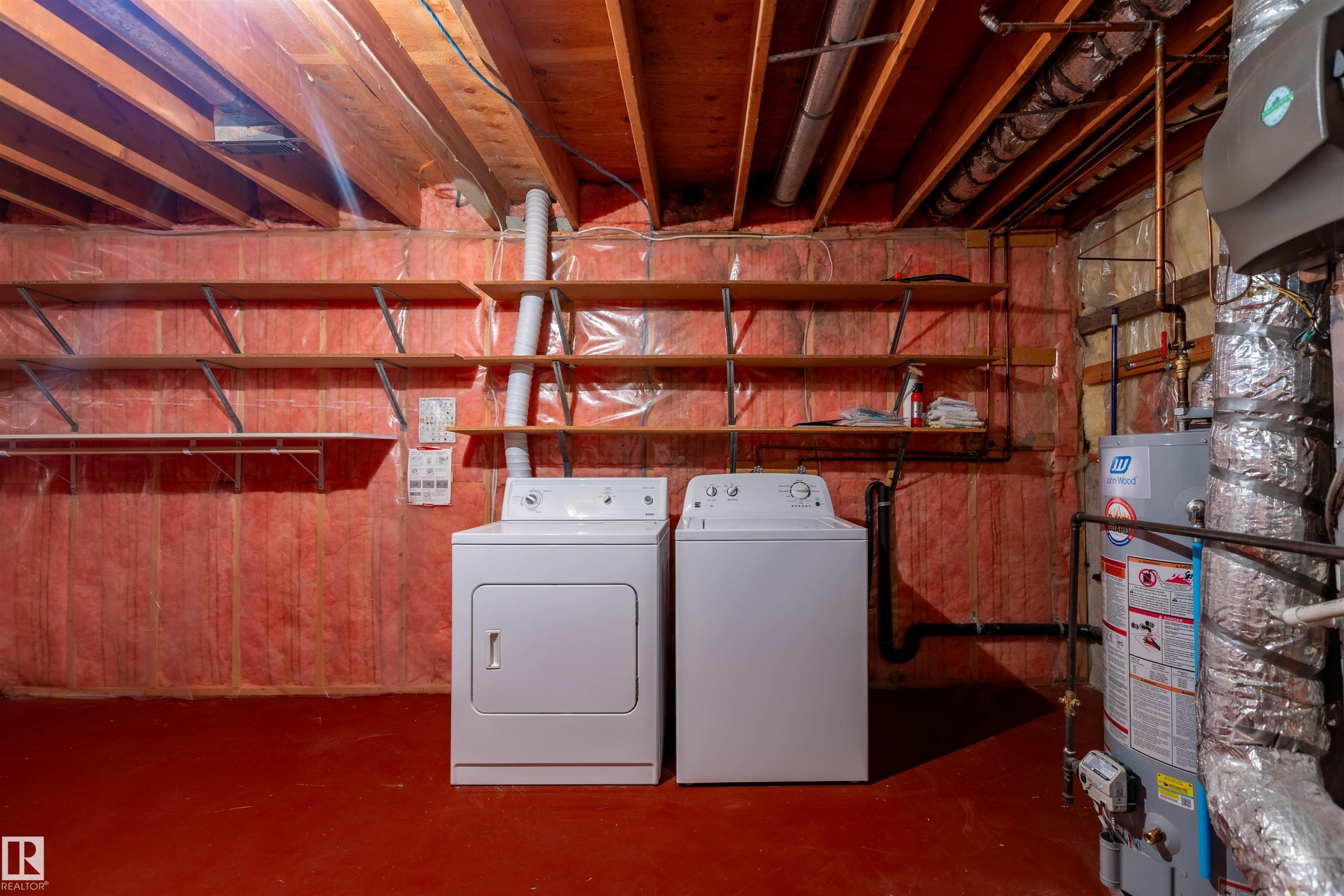 Utility area featuring a water heater, exposed wood joists, and a concrete floor - 3 Glenforest Crescent, Stony Plain, AB