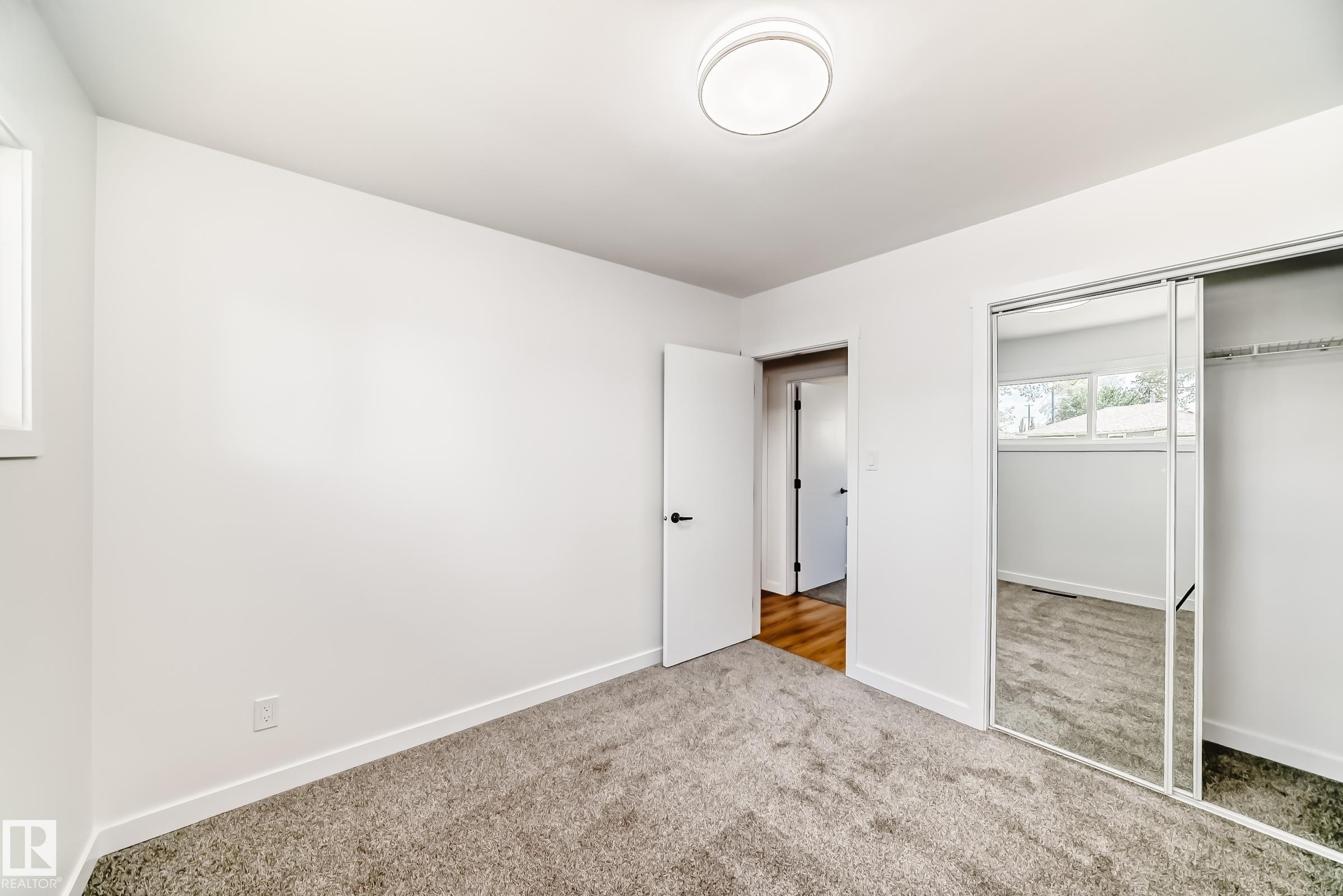 Carpeted room with white walls and trim - 4842 116Ave, Edmonton, AB