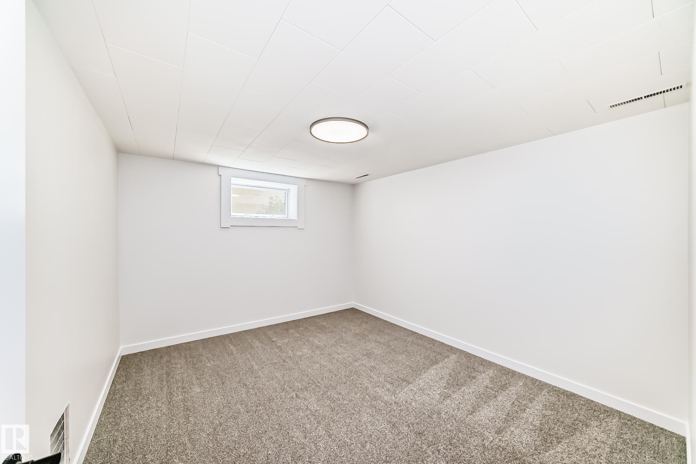Carpeted room with white painted walls and trim - 4842 116Ave, Edmonton, AB