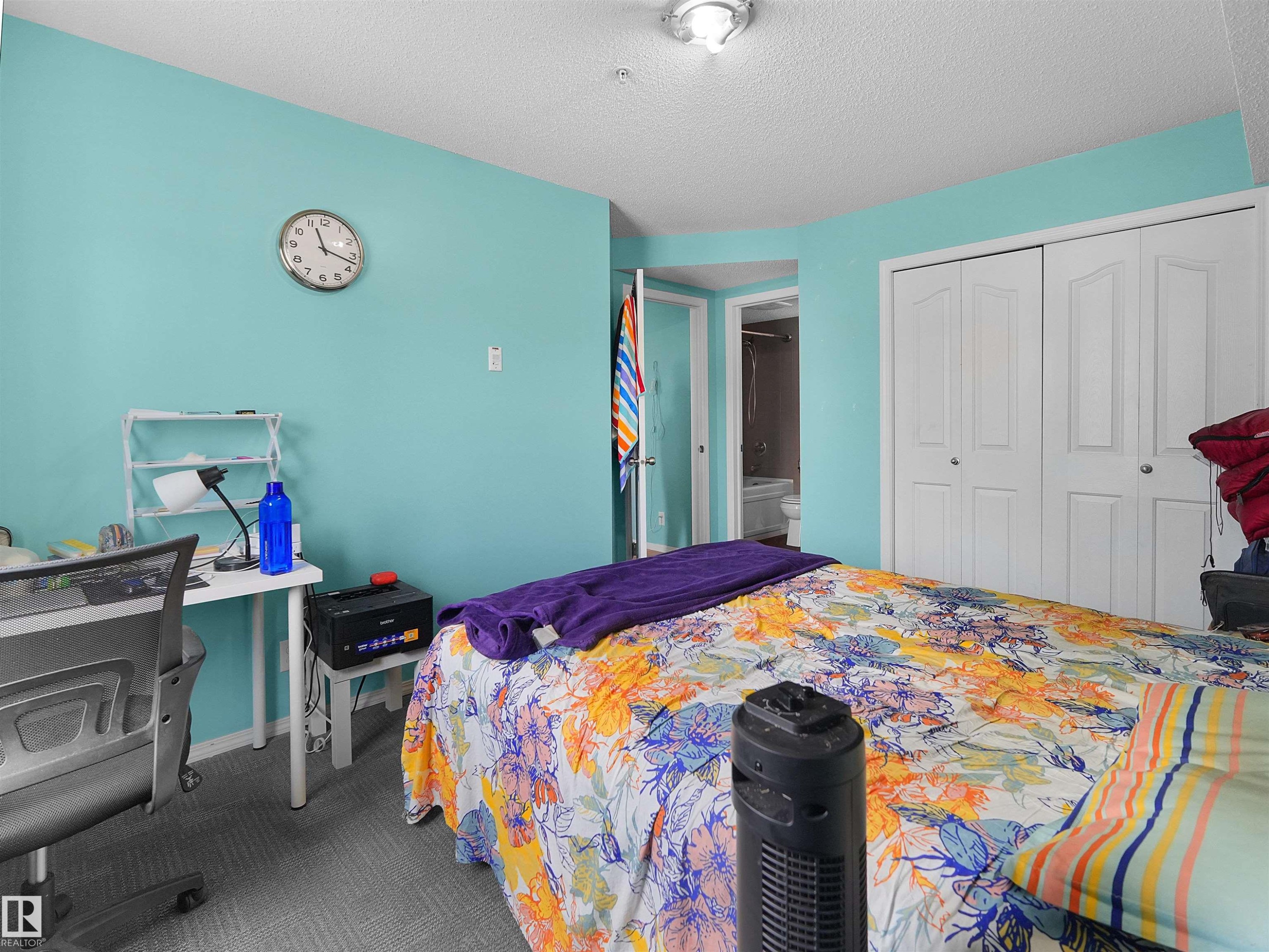 Bedroom featuring textured grey carpet flooring, white bi-fold closet doors, a white ceiling, and a light fixture - #313 11820 22 Av Sw, Edmonton, AB - Indoor Photo Showing Bedroom