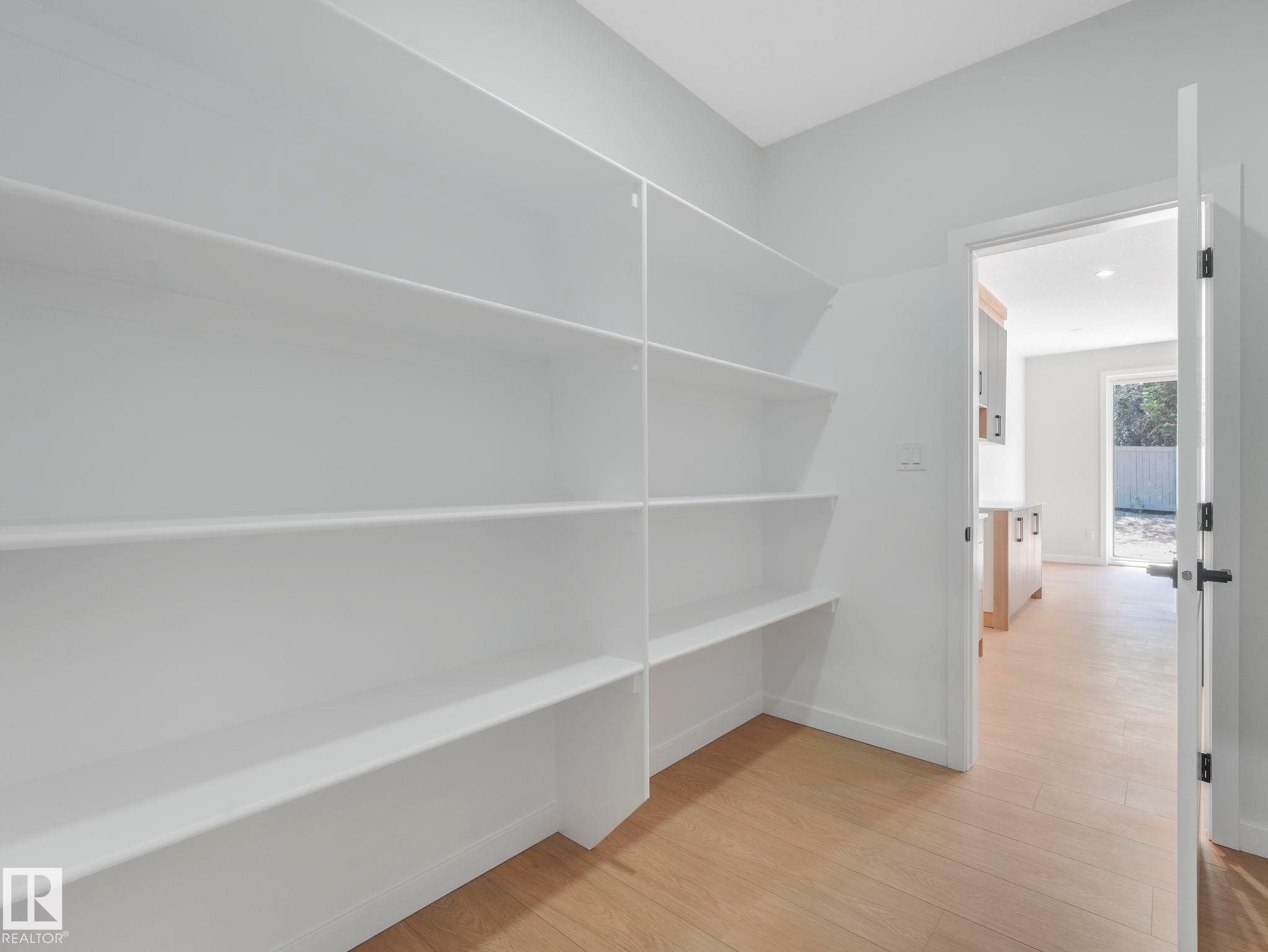 Built-in custom shelving provides extensive storage capacity - 1717 Crossbill Loop, Edmonton, AB - Indoor Photo Showing Other Room