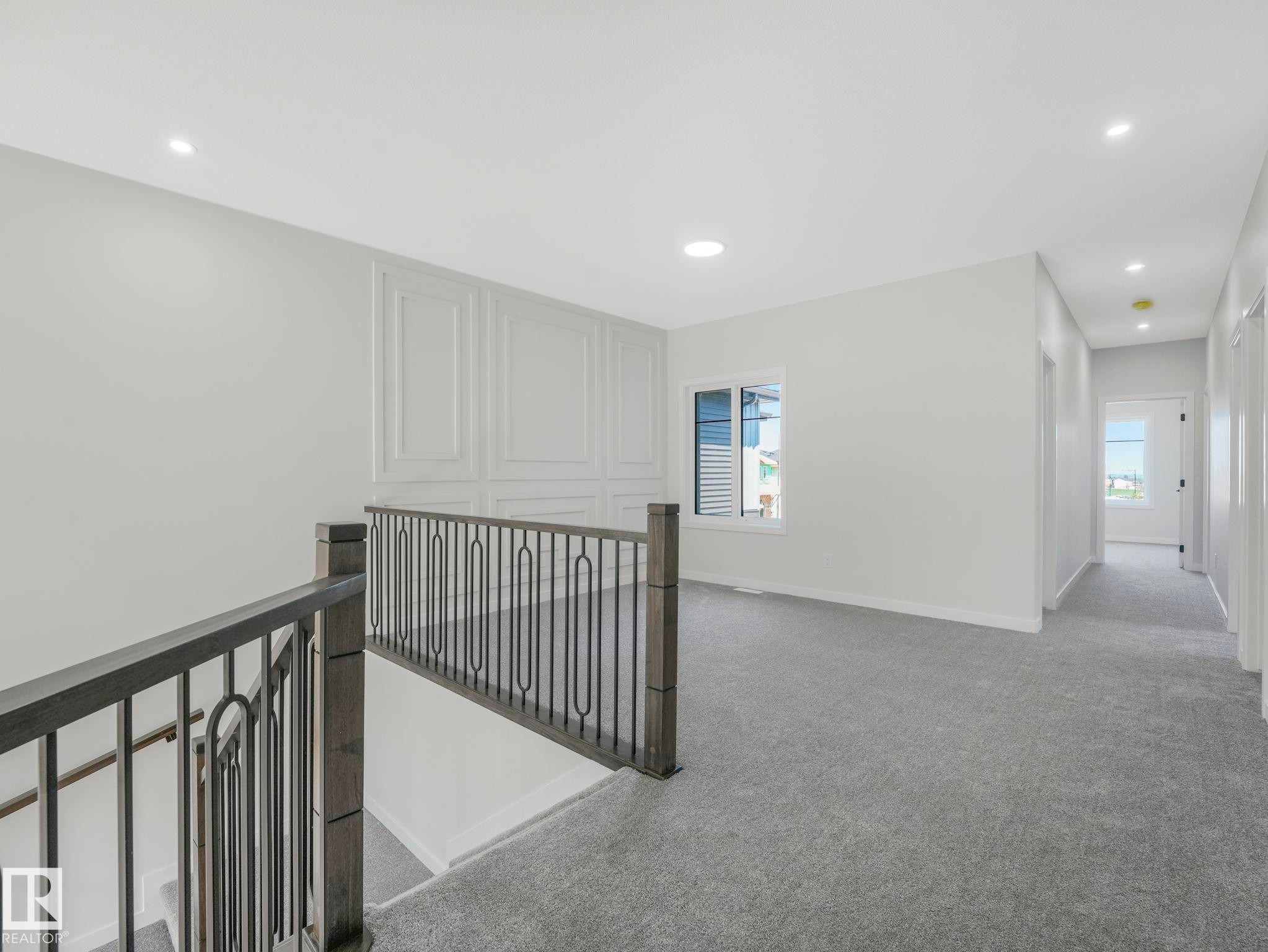 Upper level landing featuring gray carpeting and white walls - 1717 Crossbill Loop, Edmonton, AB - Indoor Photo Showing Other Room