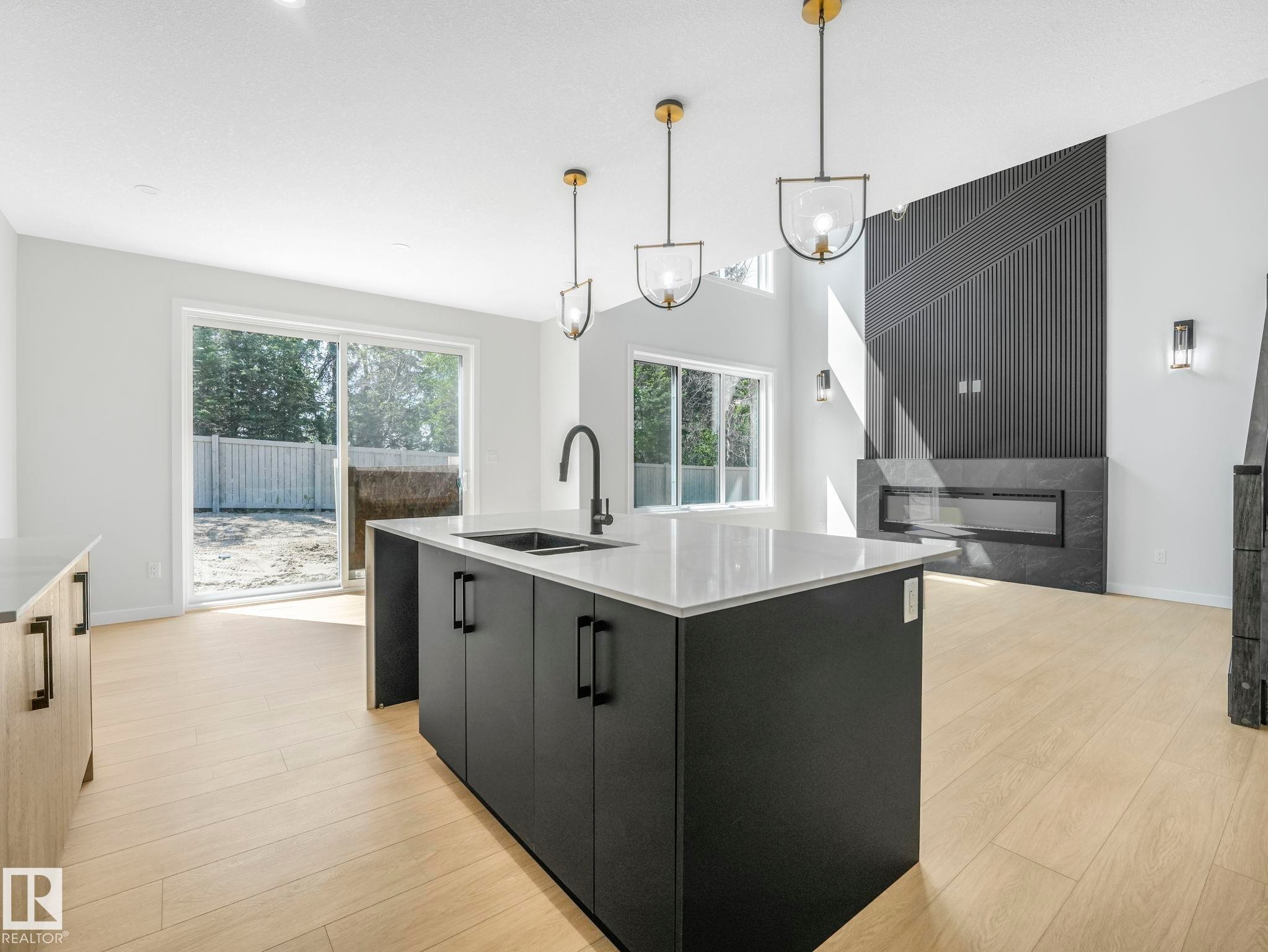 Modern kitchen island featuring a quartz countertop and integrated sink - 1717 Crossbill Loop, Edmonton, AB - Indoor Photo Showing Kitchen With Double Sink With Upgraded Kitchen