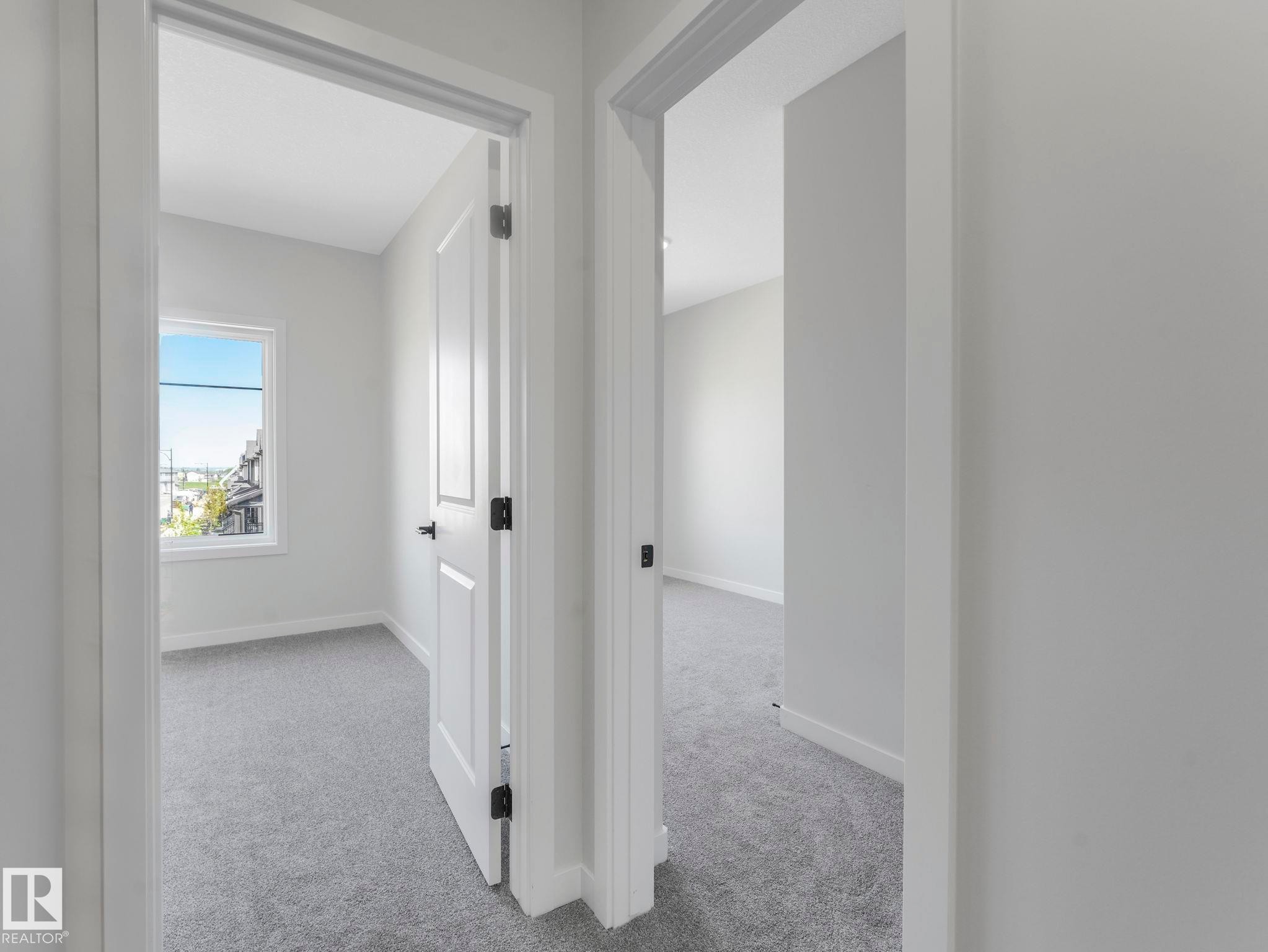 Neutral gray wall finishes throughout, complemented by white trim and doors - 1717 Crossbill Loop, Edmonton, AB - Indoor Photo Showing Other Room