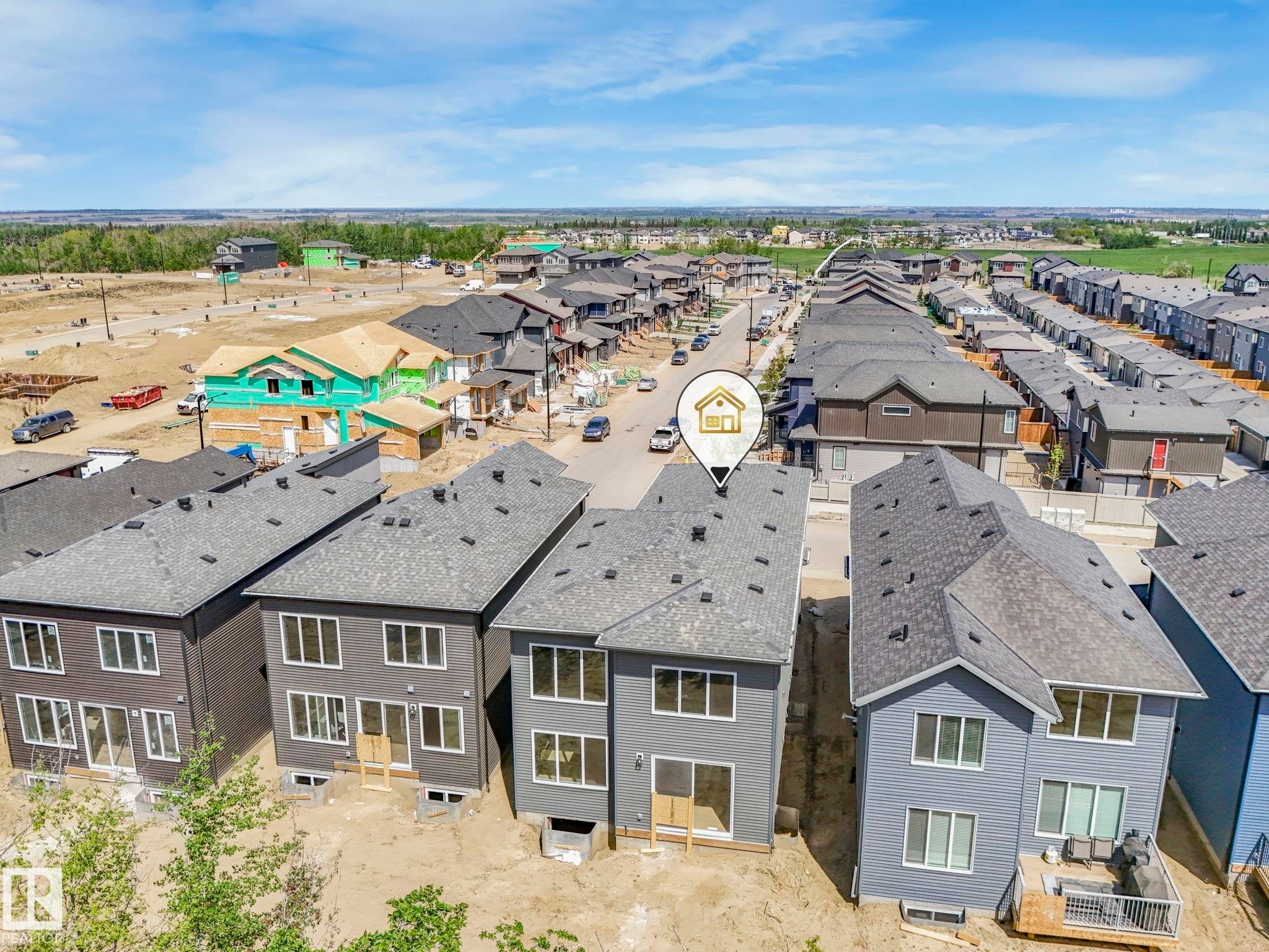 Newly constructed residential property featuring gray siding and a dark shingle roof - 1717 Crossbill Loop, Edmonton, AB - Outdoor