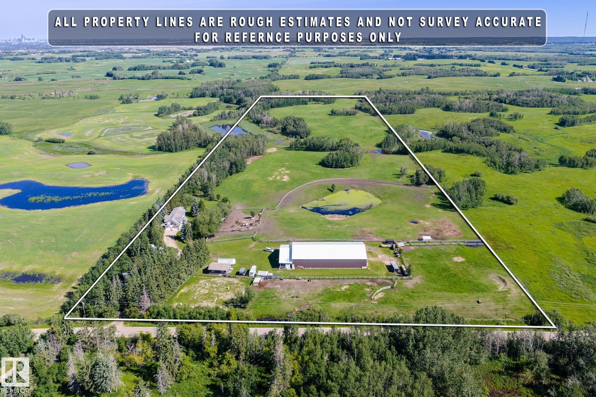 Expansive aerial property featuring a main residence, a large outbuilding, and significant open land - 860 41 Avenue, Edmonton, AB