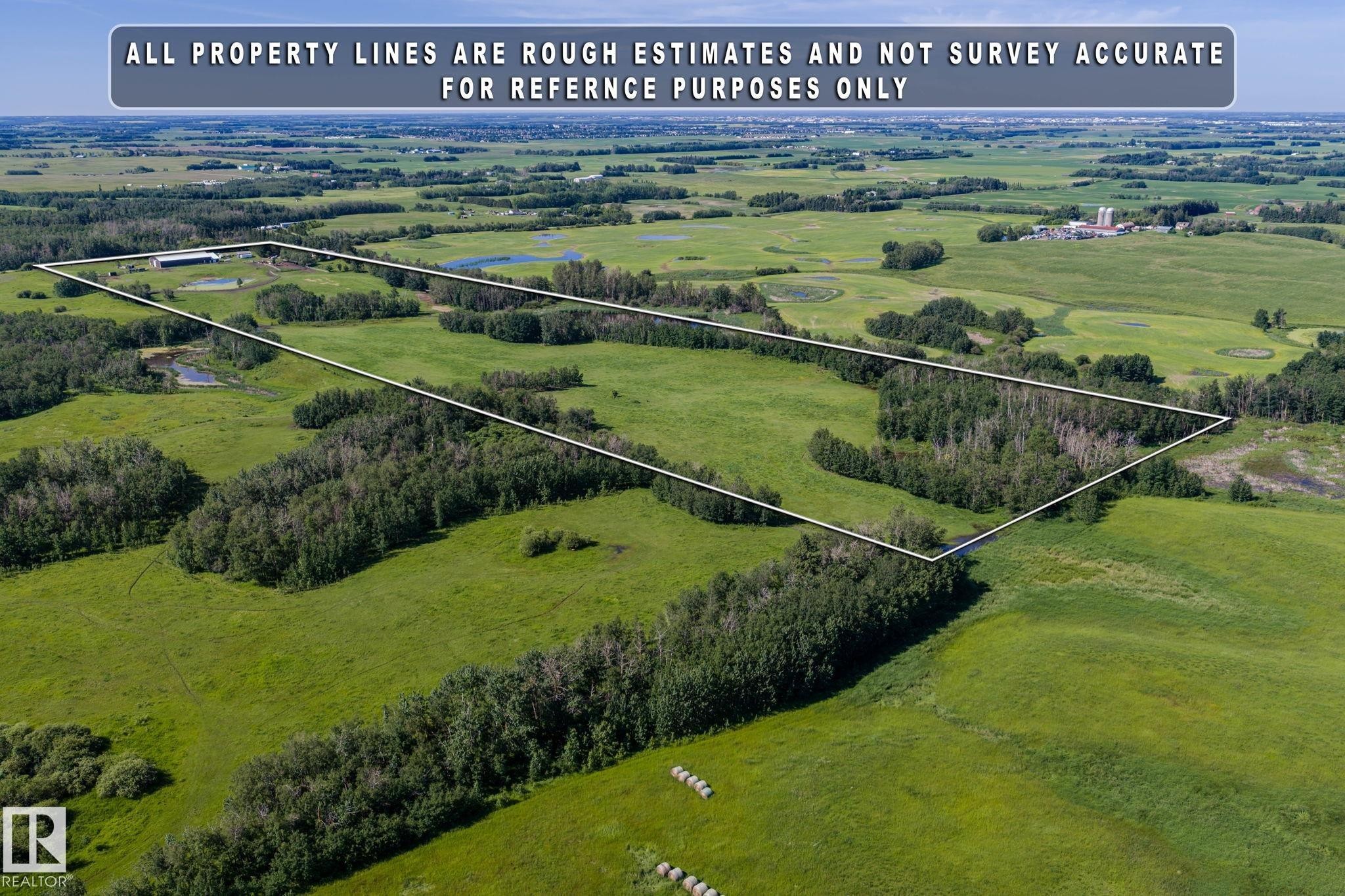 Expansive agricultural land featuring a mix of open fields and mature tree lines - 860 41 Avenue, Edmonton, AB