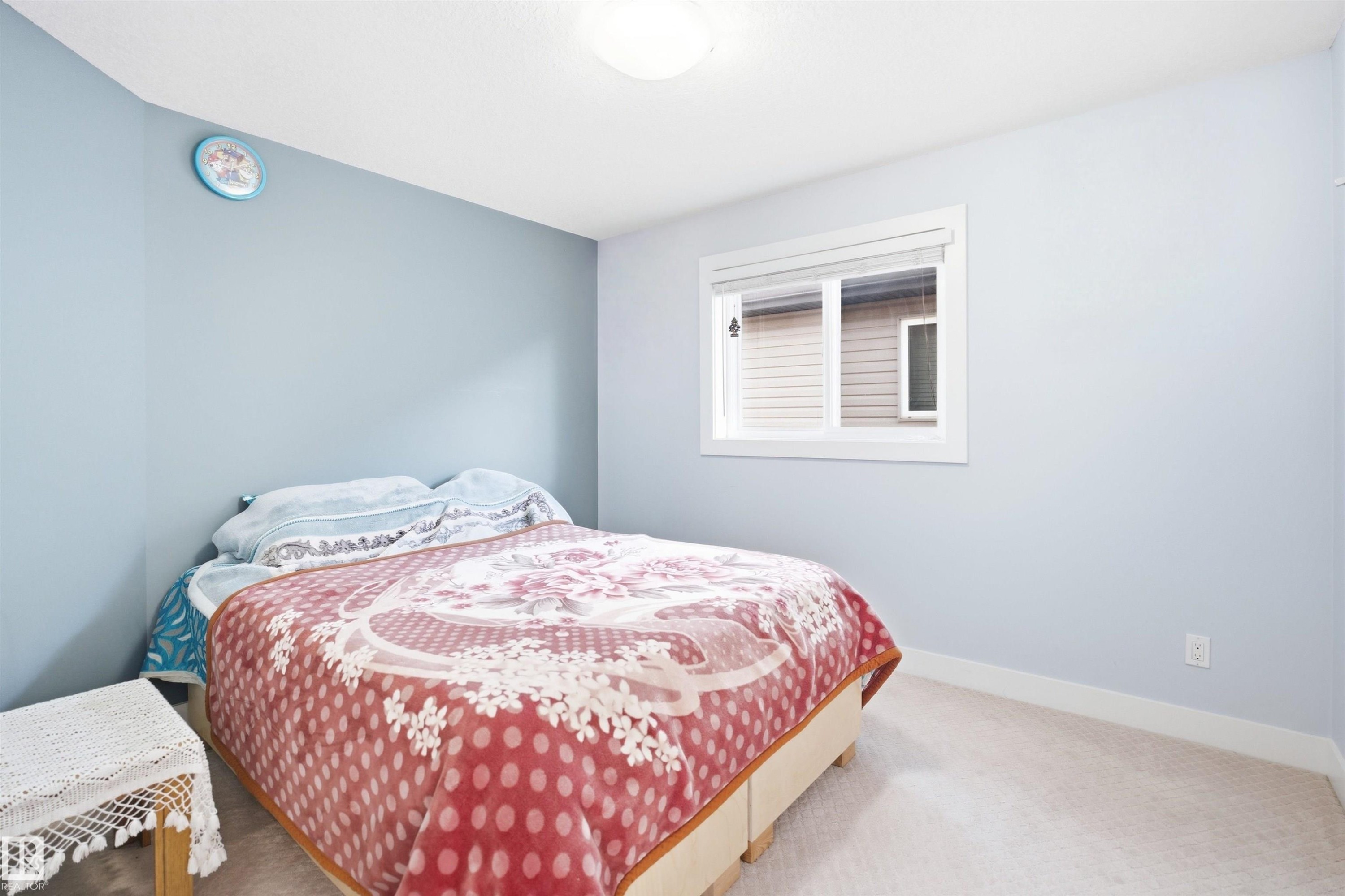 Neutral wall paint, white trim, recessed window with blinds, light-toned carpeting - 6014 60 Street, Beaumont, AB - Indoor Photo Showing Bedroom