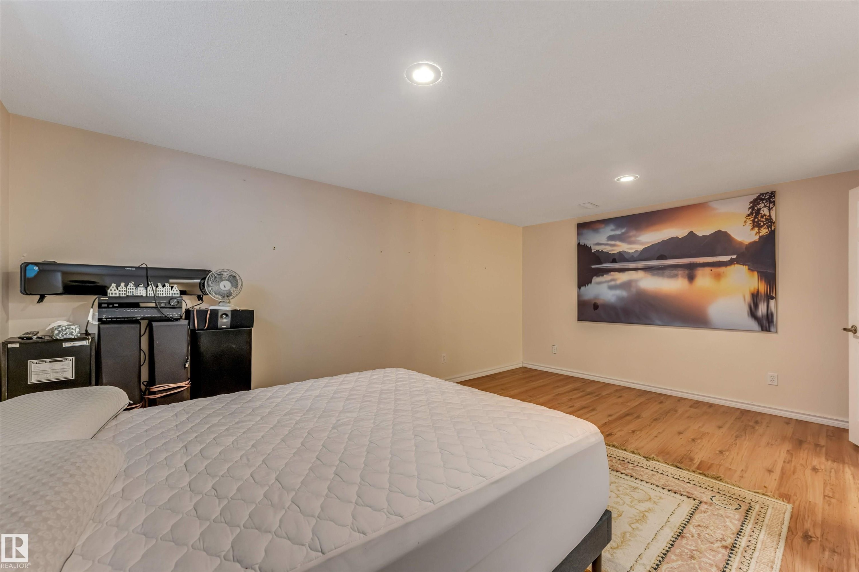 Spacious room featuring light-colored walls, wood-finish flooring, and recessed ceiling lighting - 3032 31 Avenue, Edmonton, AB - Indoor Photo Showing Bedroom